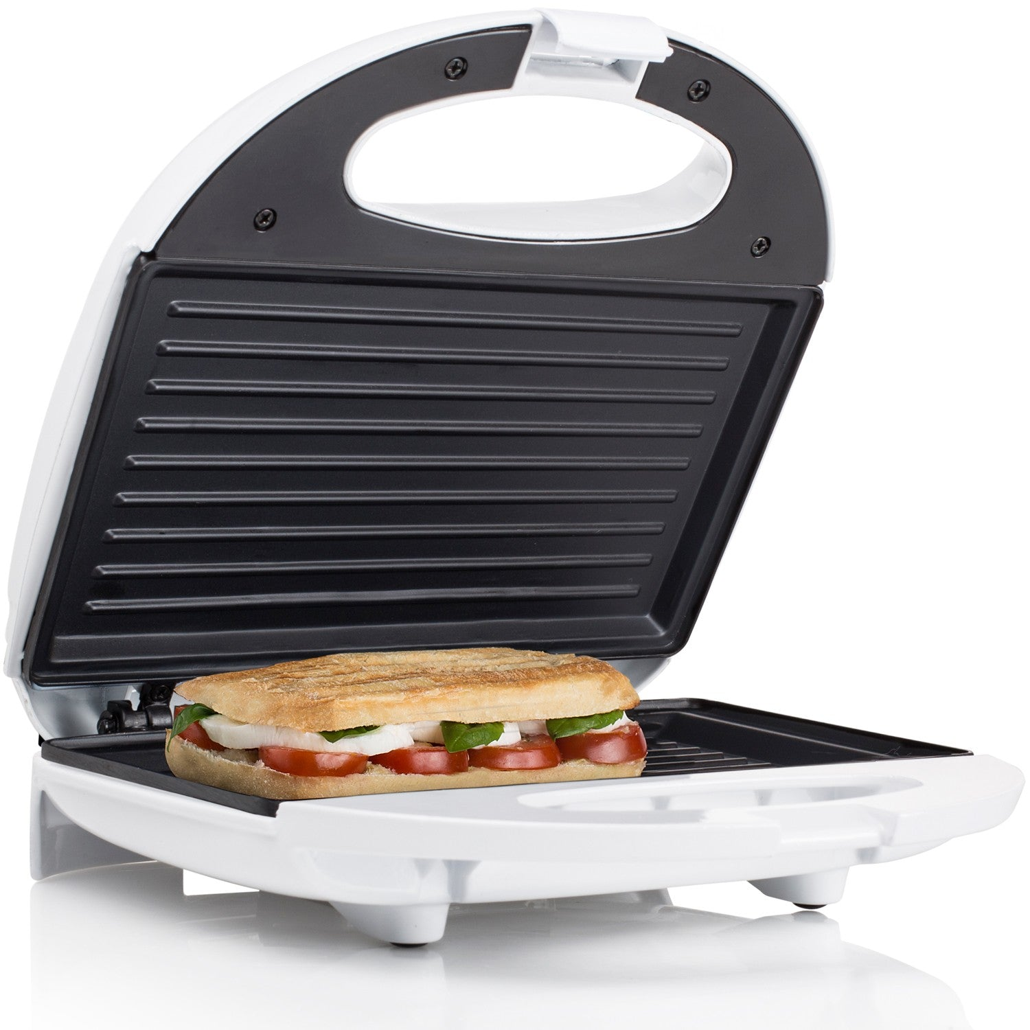 An open white sandwich maker with a sandwich made of bread, tomatoes, mozzarella, and basil.