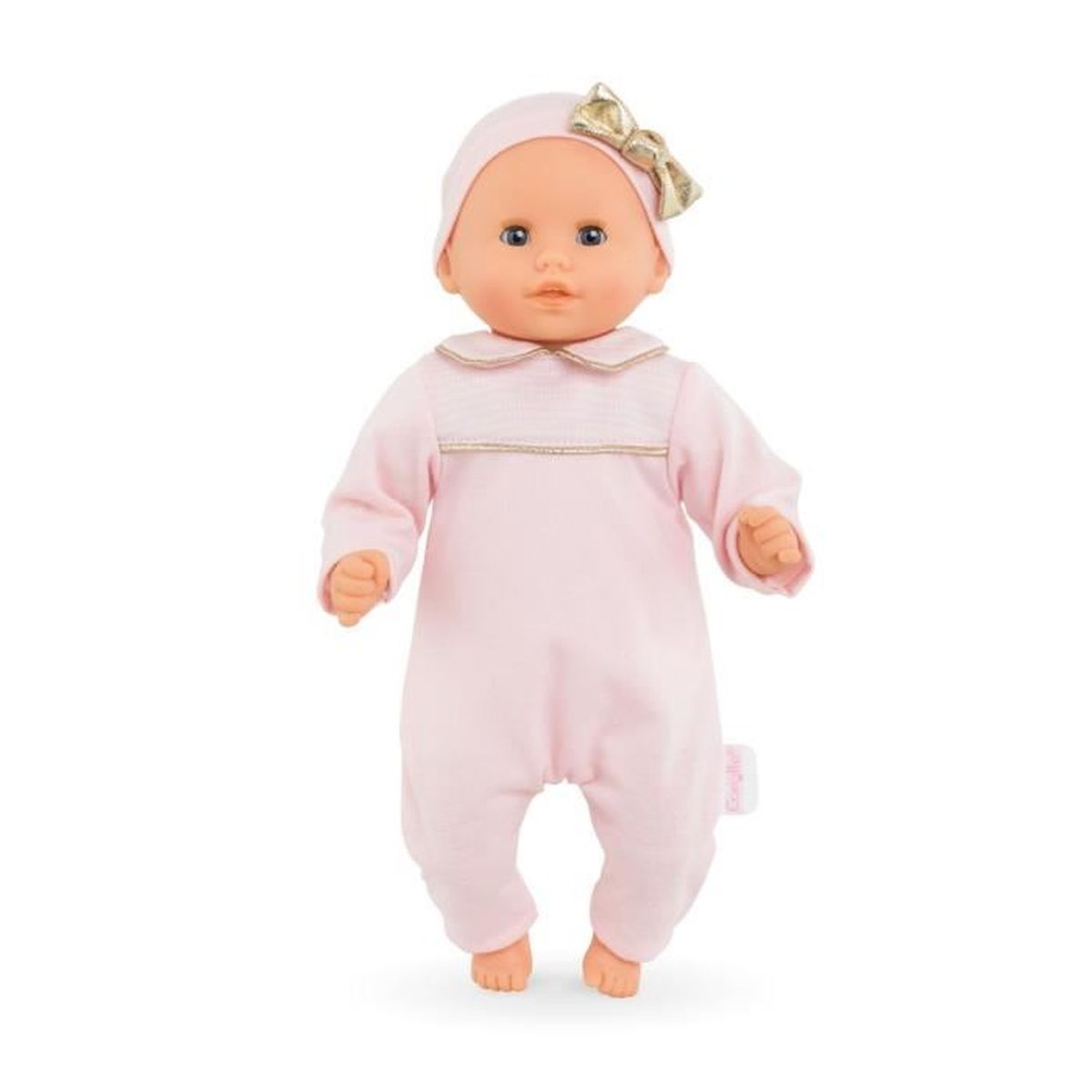 Ein Baby-Puppe in rosa Strampler mit goldener Schleife auf der Mütze.