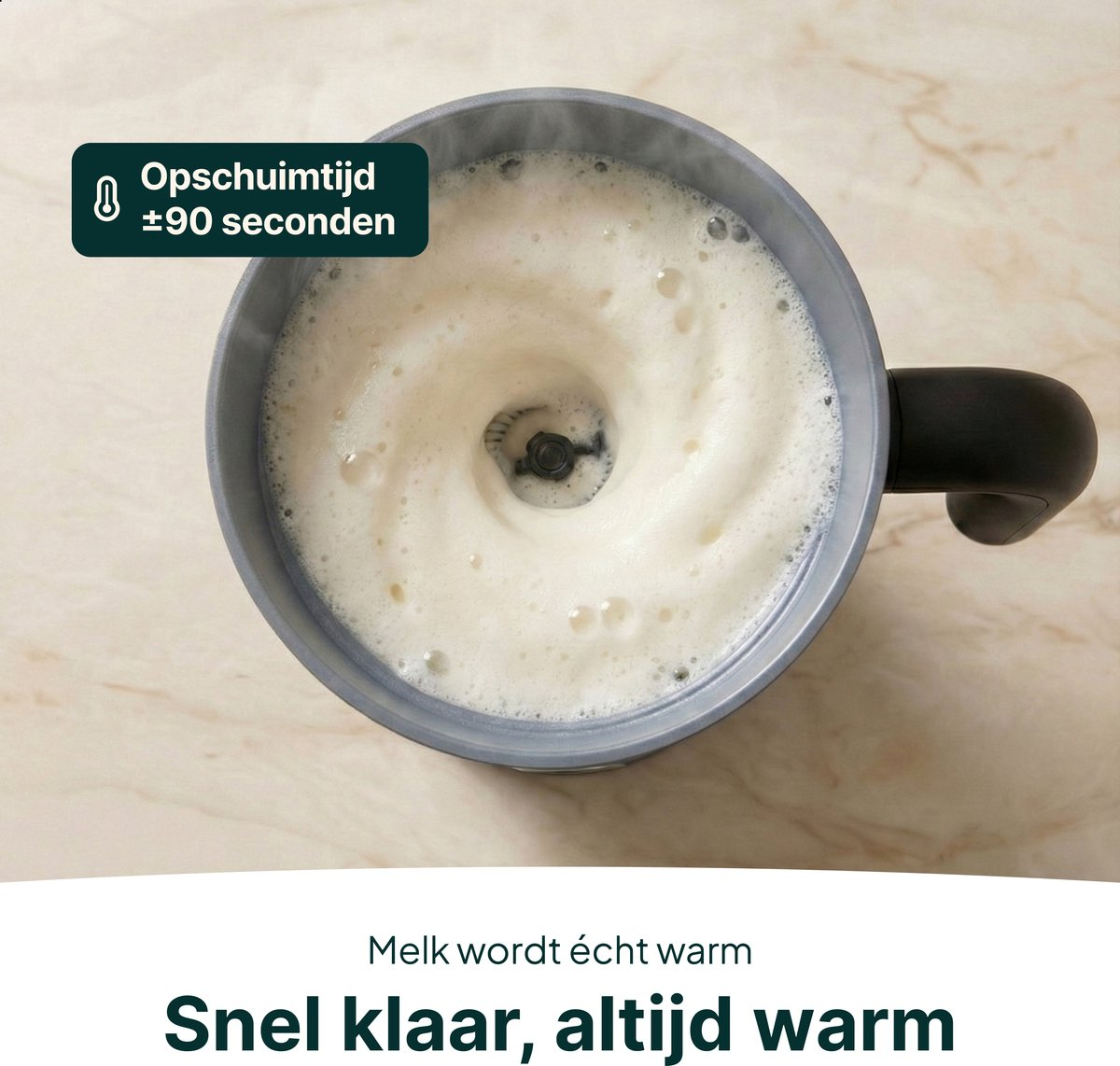 Milk frother with foamy milk and a whisk in the center.