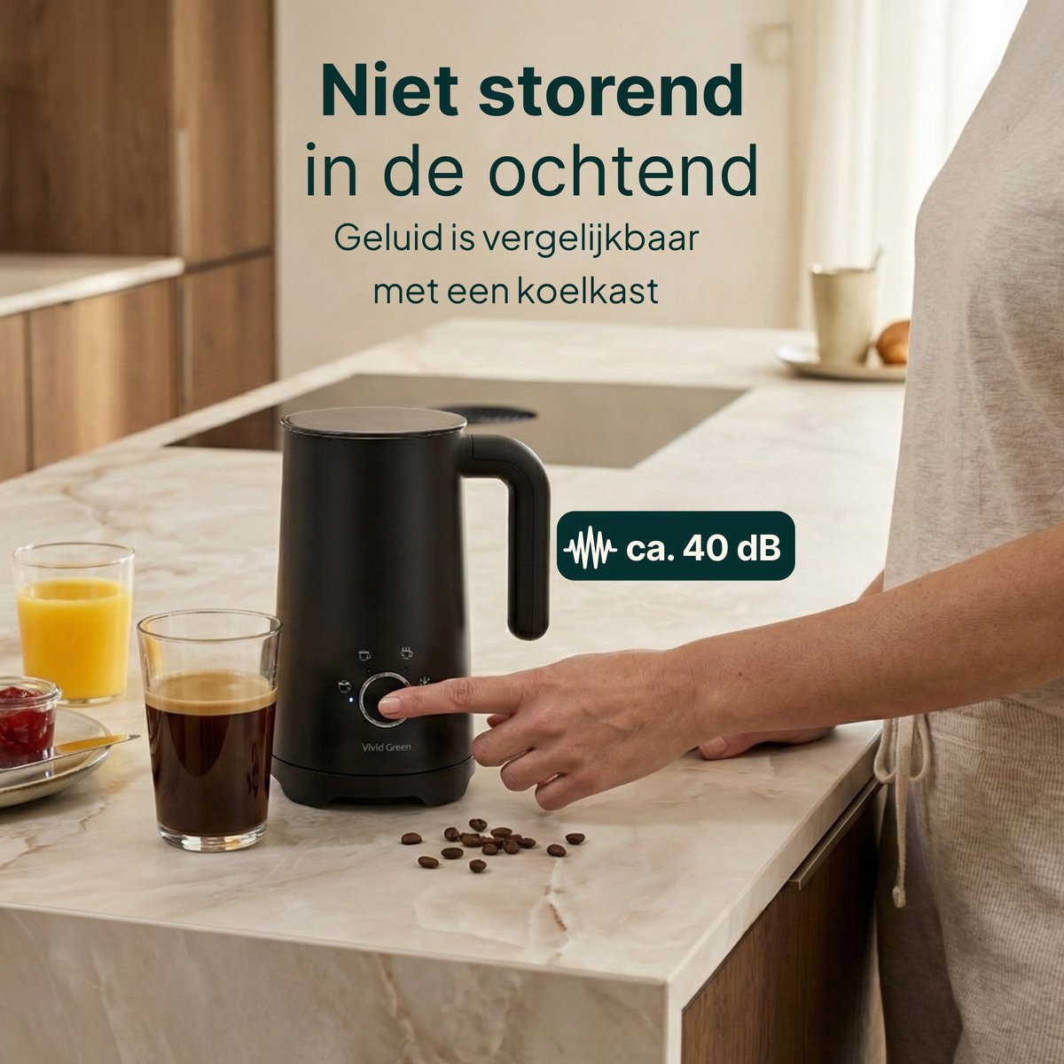 Black milk frother with coffee beans, juice, and coffee on a marble countertop.