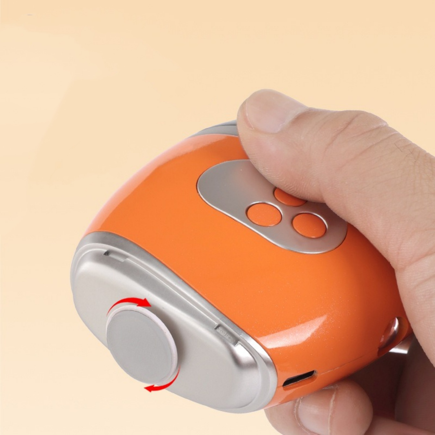 Hand hält ein orange-silbernes Gerät mit Knöpfen. Ein Rad dreht sich.