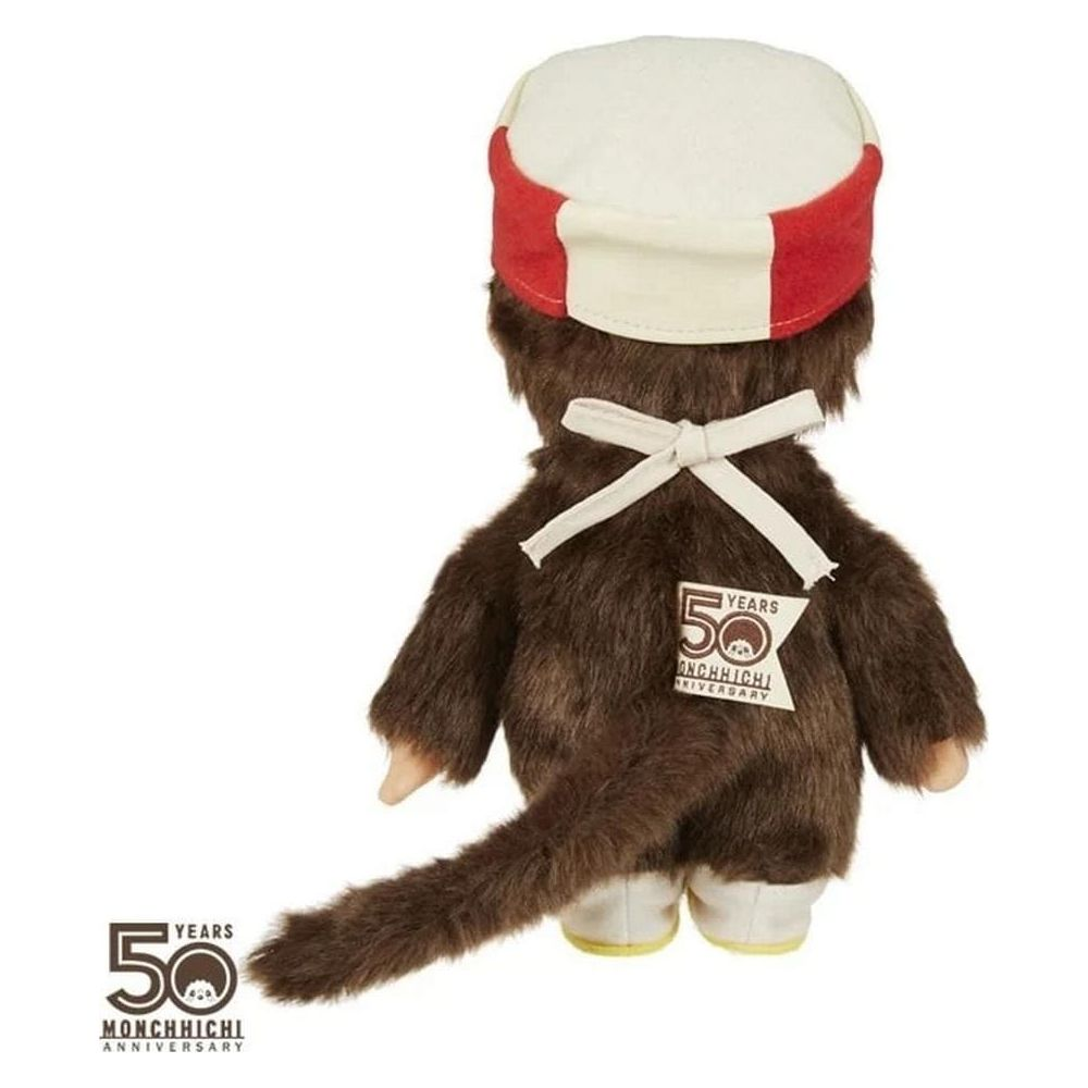 Bambola di peluche marrone con cappello bianco e rosso, nastro bianco e logo 50 anni.