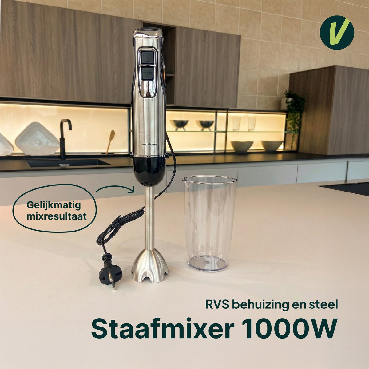A silver immersion blender with a black handle and a clear measuring cup rest on a countertop.
