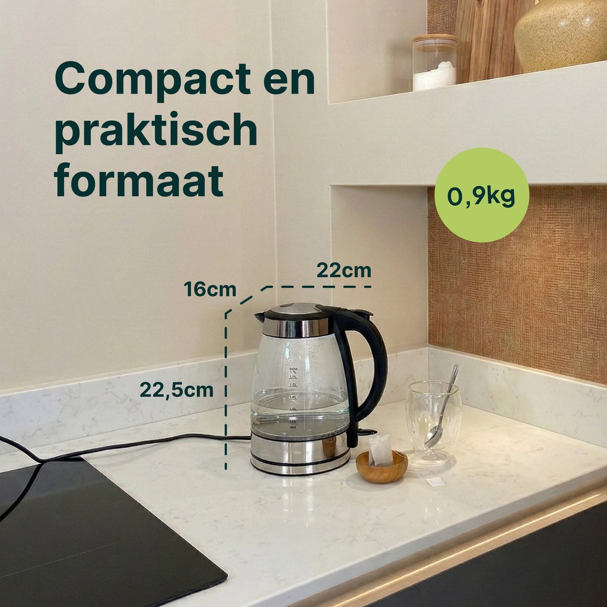 Glass kettle (22.5cm H, 16cm W) weighing 0.9kg, with a cup next to it.