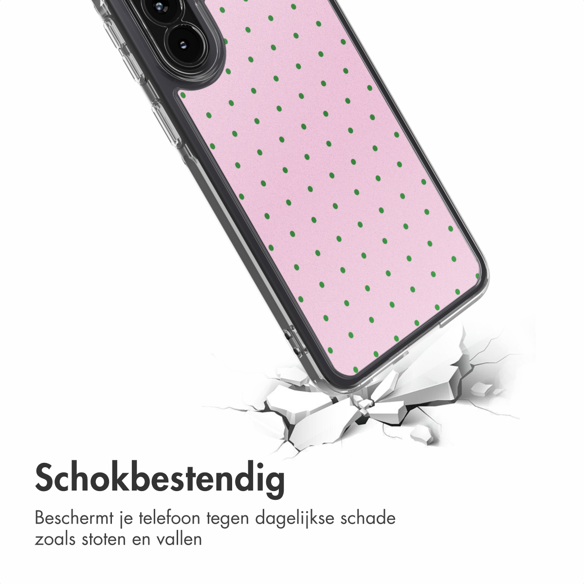 Una cover per telefono rosa a pois verdi cade, frantumando il terreno.