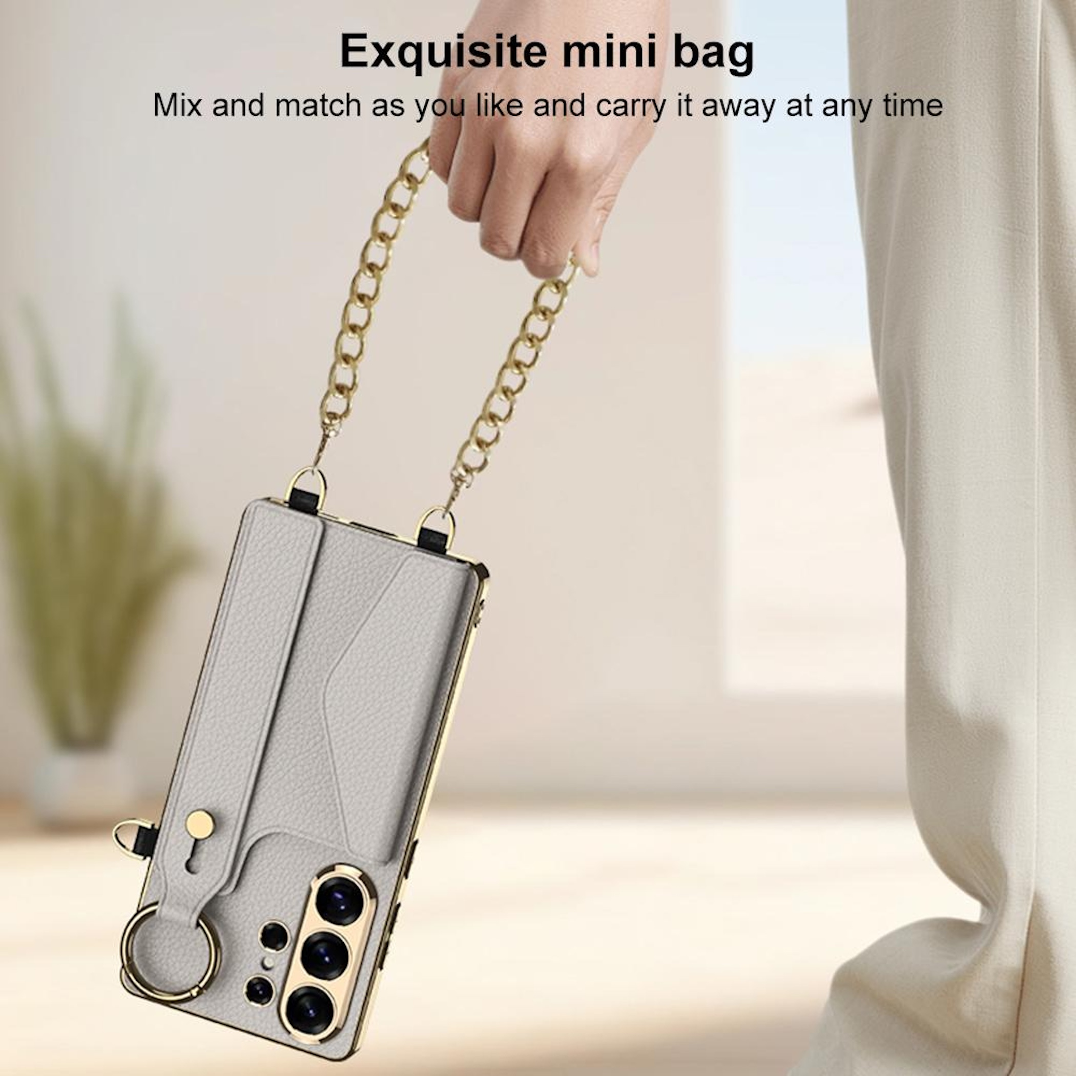 Graue Handyhülle mit Kette wird von einer Hand gehalten.