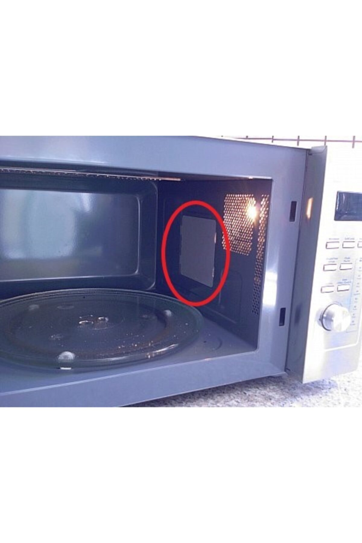 Cam döner tabla ve dikdörtgen kapaklı açık mikrodalga içi.