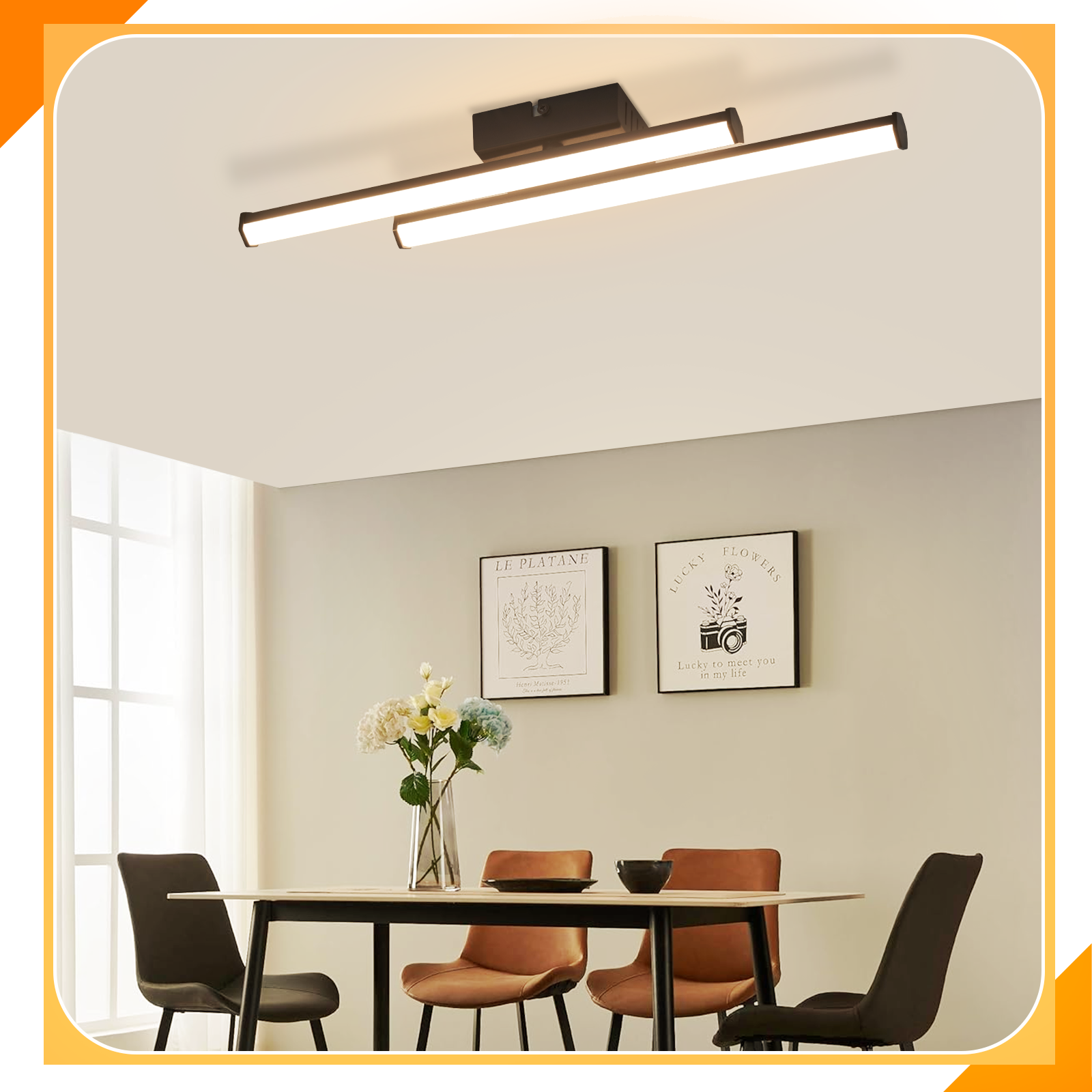 Un lampadario moderno sopra un tavolo da pranzo con sedie, fiori e opere d'arte.
