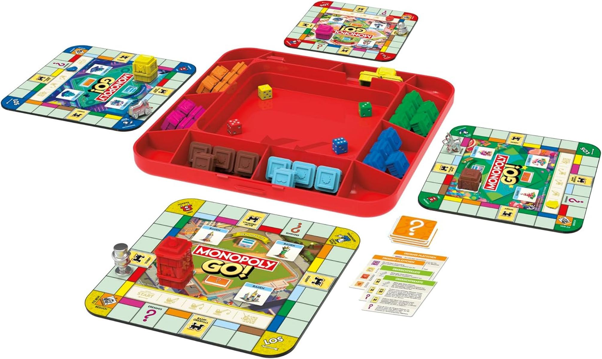 Tabellone Monopoly Go! con pezzi, dadi e carte in un vassoio rosso.
