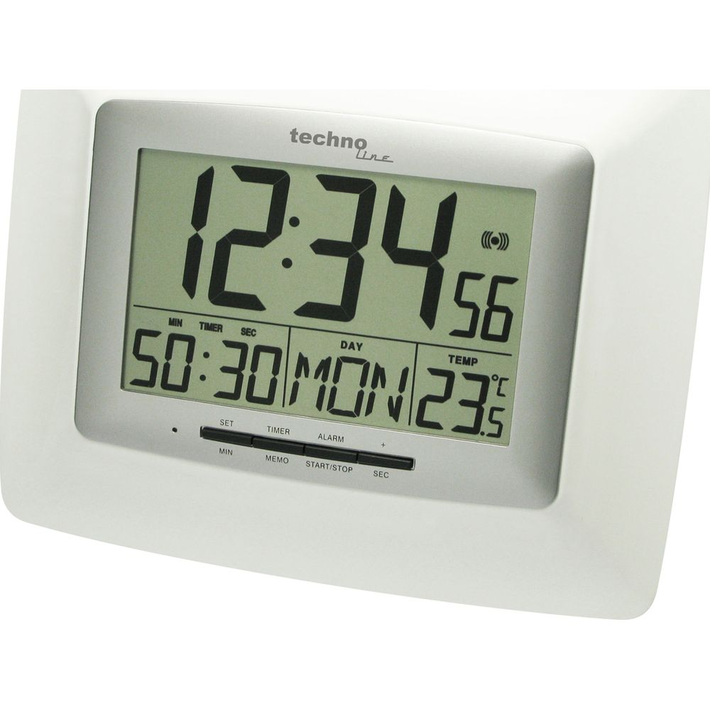 Eine weiße TechnoLine Digitaluhr zeigt 12:34 Uhr, Datum 50:30, Tag Mo und 23,5°C an.