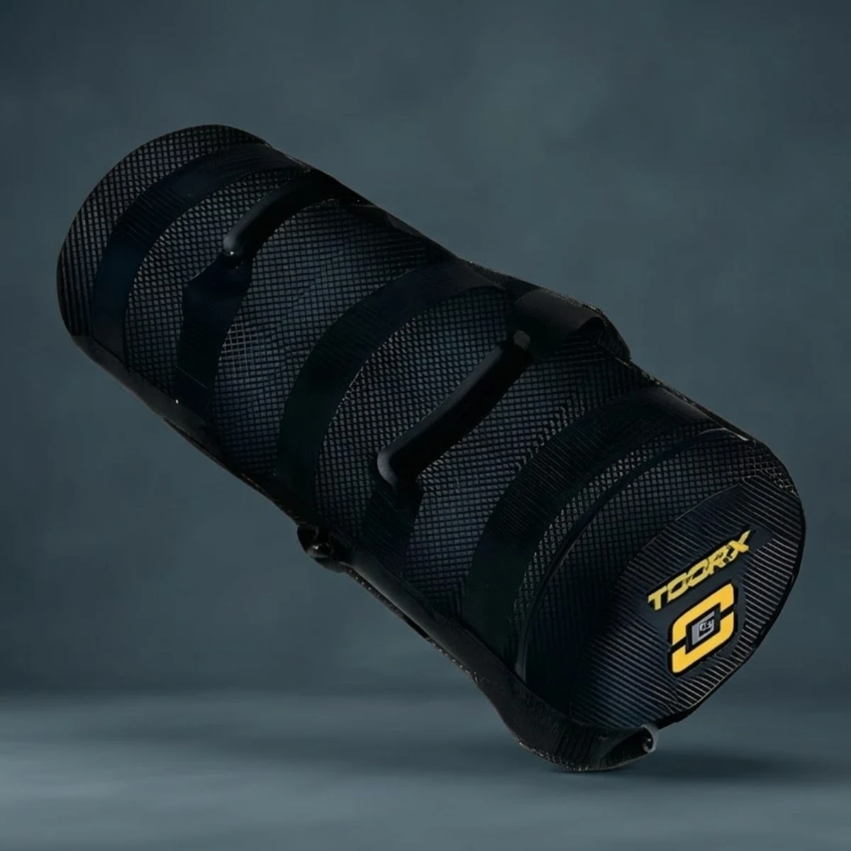 Black cylindrical training bag with handles and yellow logo.