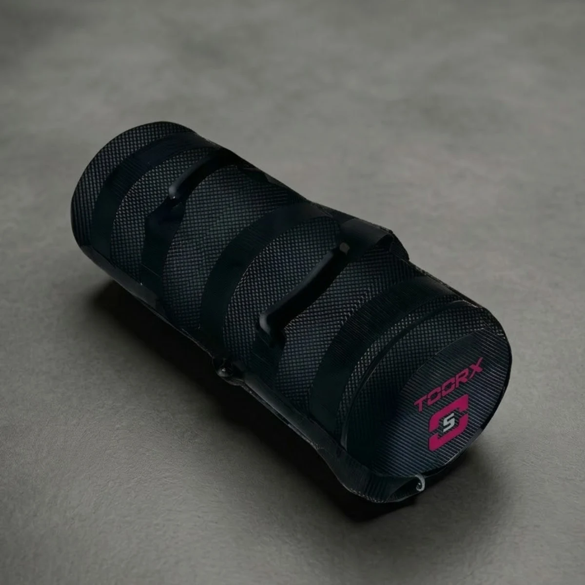 Black cylindrical grip with textured surface and pink logo.