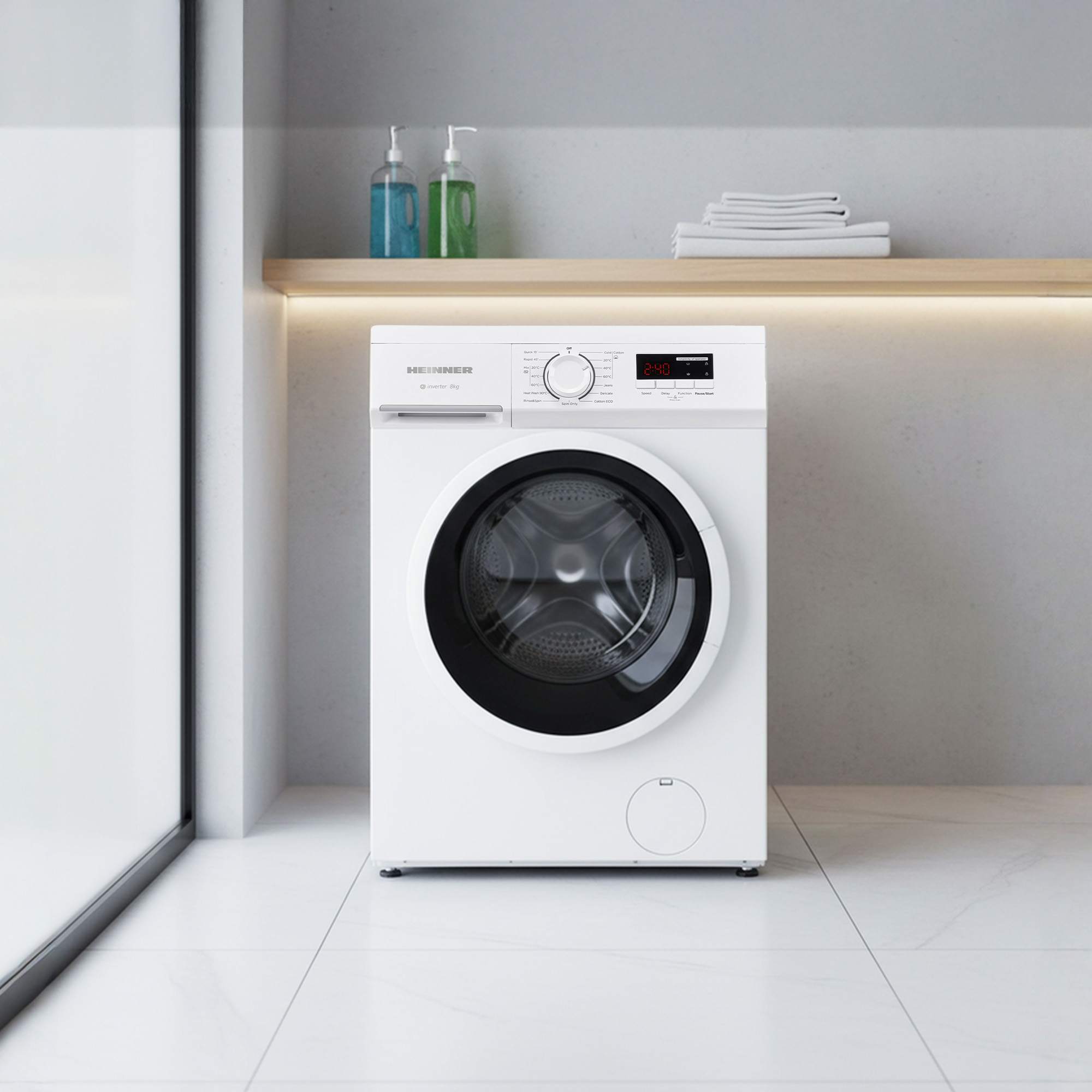 White washing machine with black door and control panel. Soap and towels nearby.
