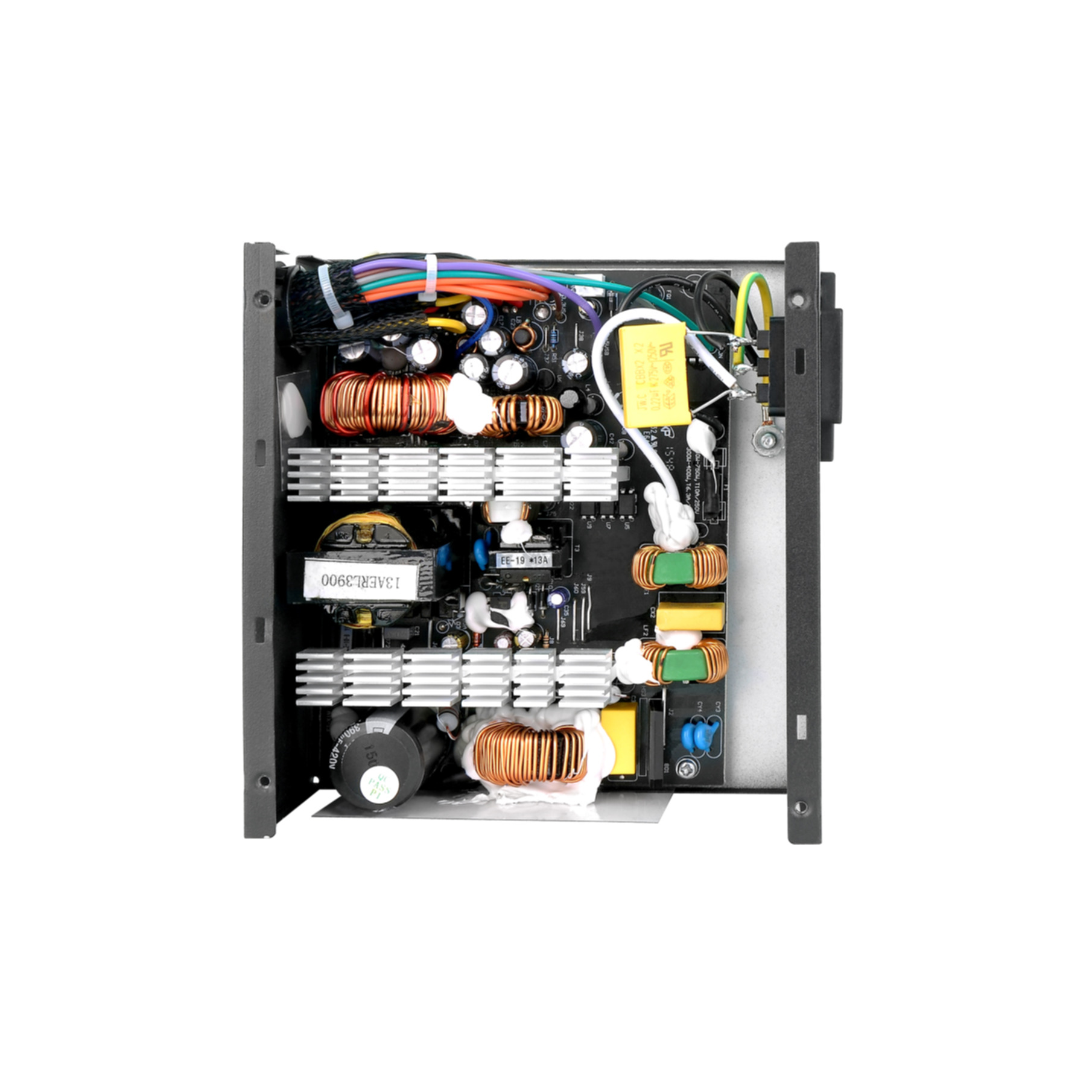 An open power supply unit showing its circuit board, coils, capacitors, and wires.