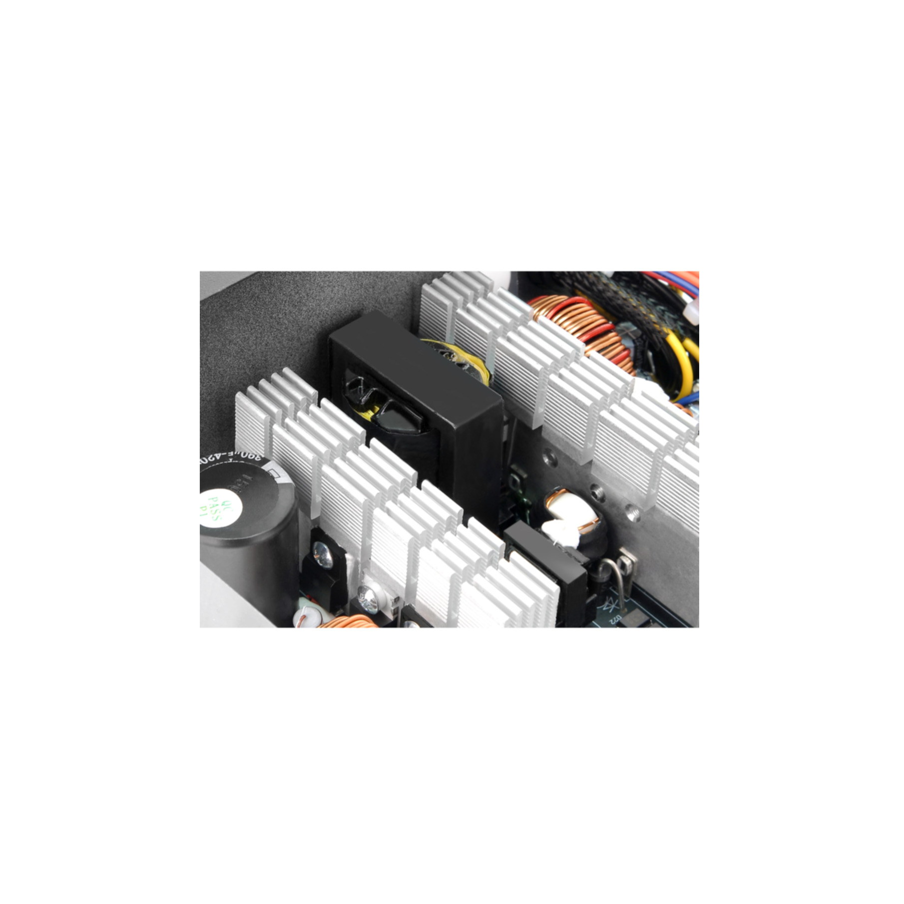 Close-up of computer power supply components with heatsinks and wires.