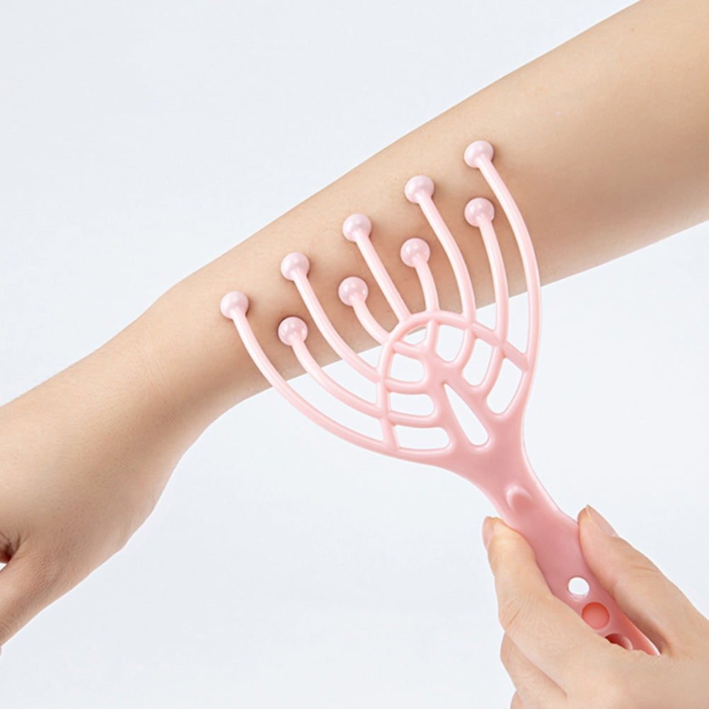 Eine rosafarbene Handmassagebürste wird auf einem Arm verwendet.