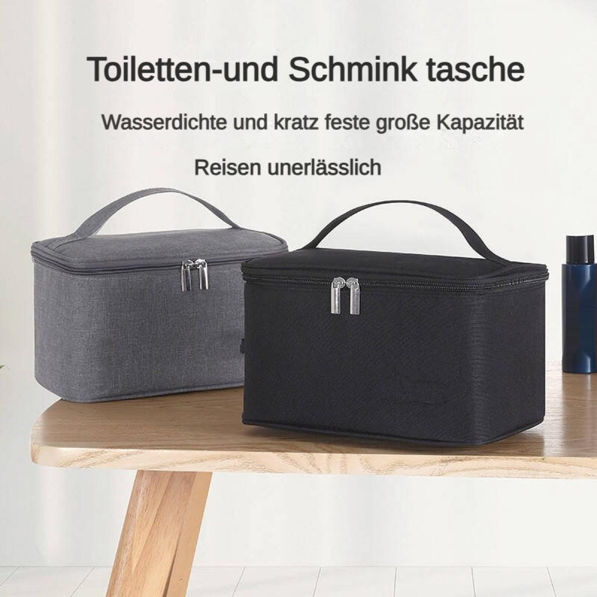 Zwei Kosmetiktaschen, eine grau und eine schwarz, auf einem Holztisch.