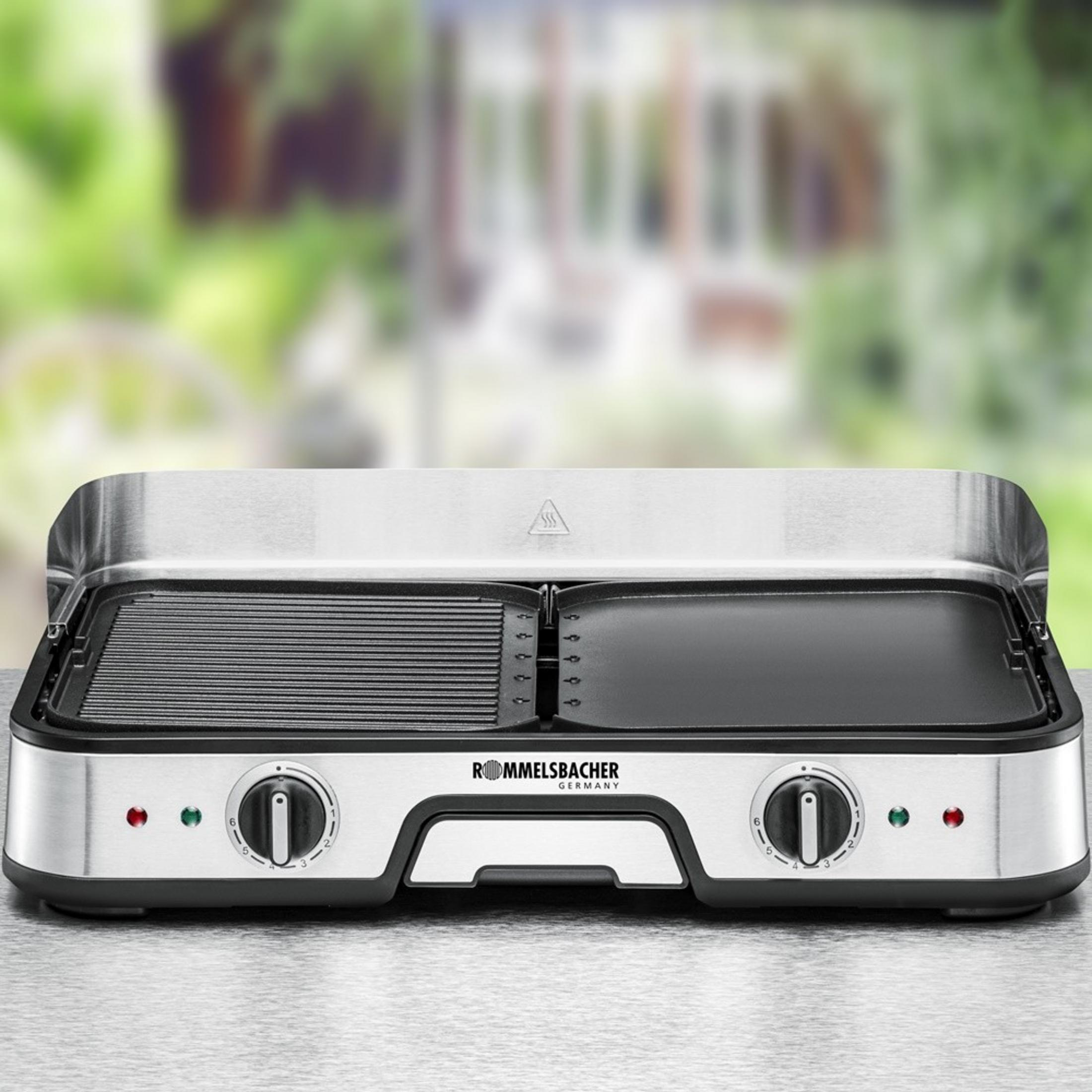 Stainless steel contact grill with ribbed and flat plates, dials, and indicator lights.