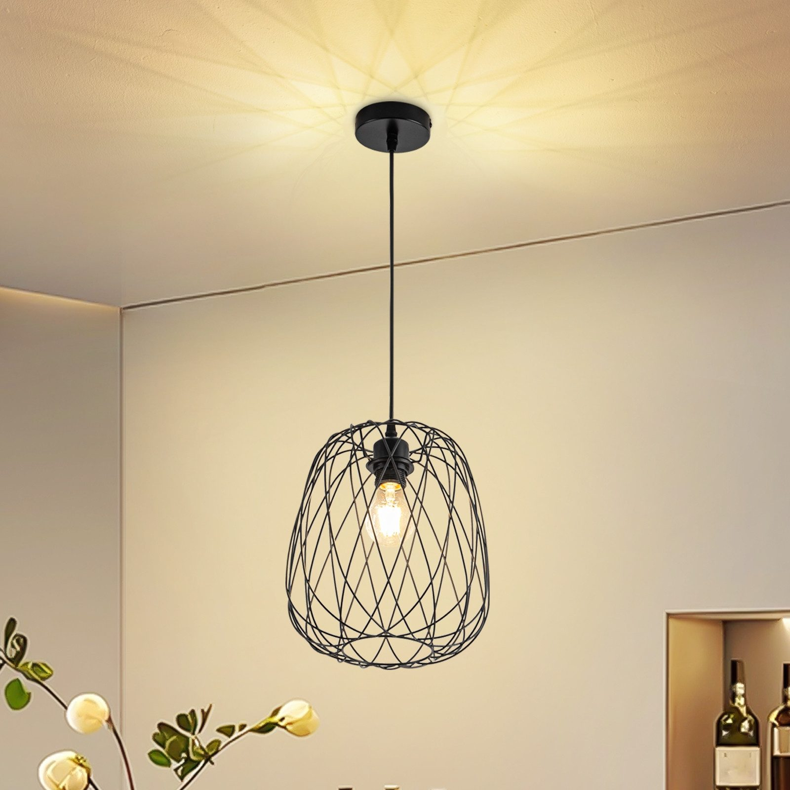 Eine schwarze Pendelleuchte mit Drahtgeflecht-Schirm hängt von der Decke.