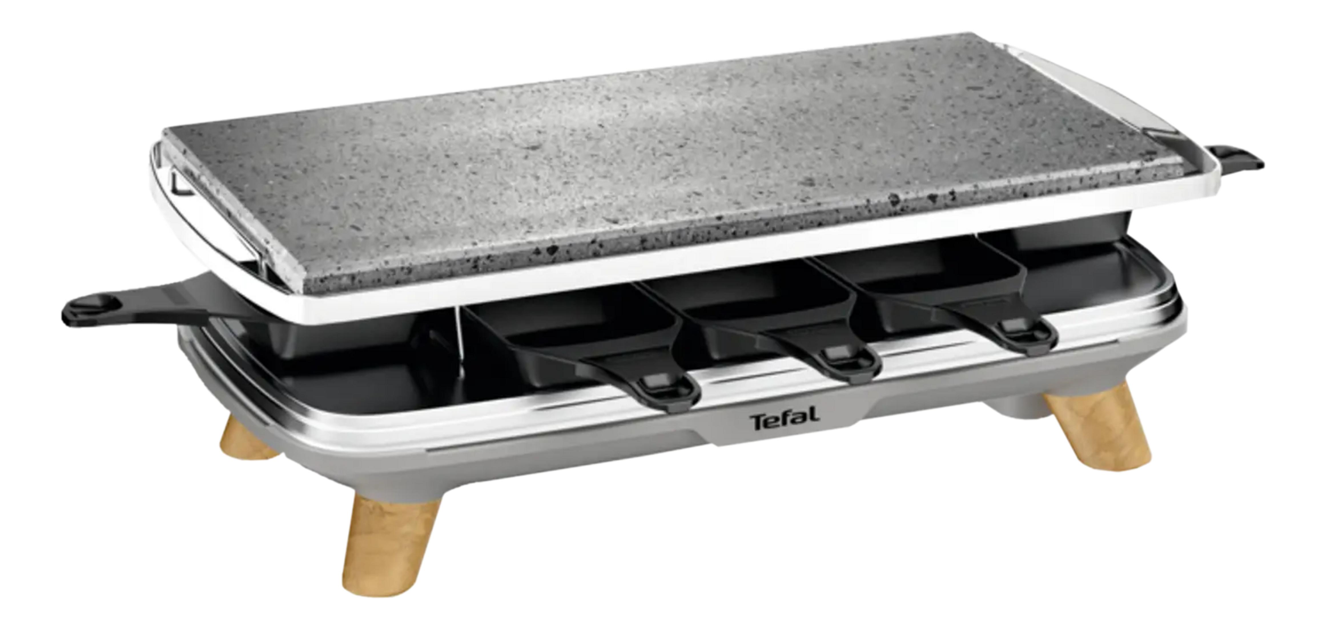 Ein Raclette-Grill mit Steinplatte und vier Pfännchen.