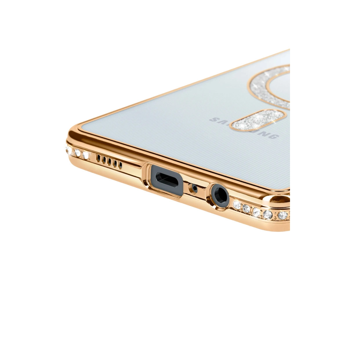 Kenarlarında taşlar olan altın rengi telefon kılıfı. USB portu ve kulaklık jakı görünüyor.