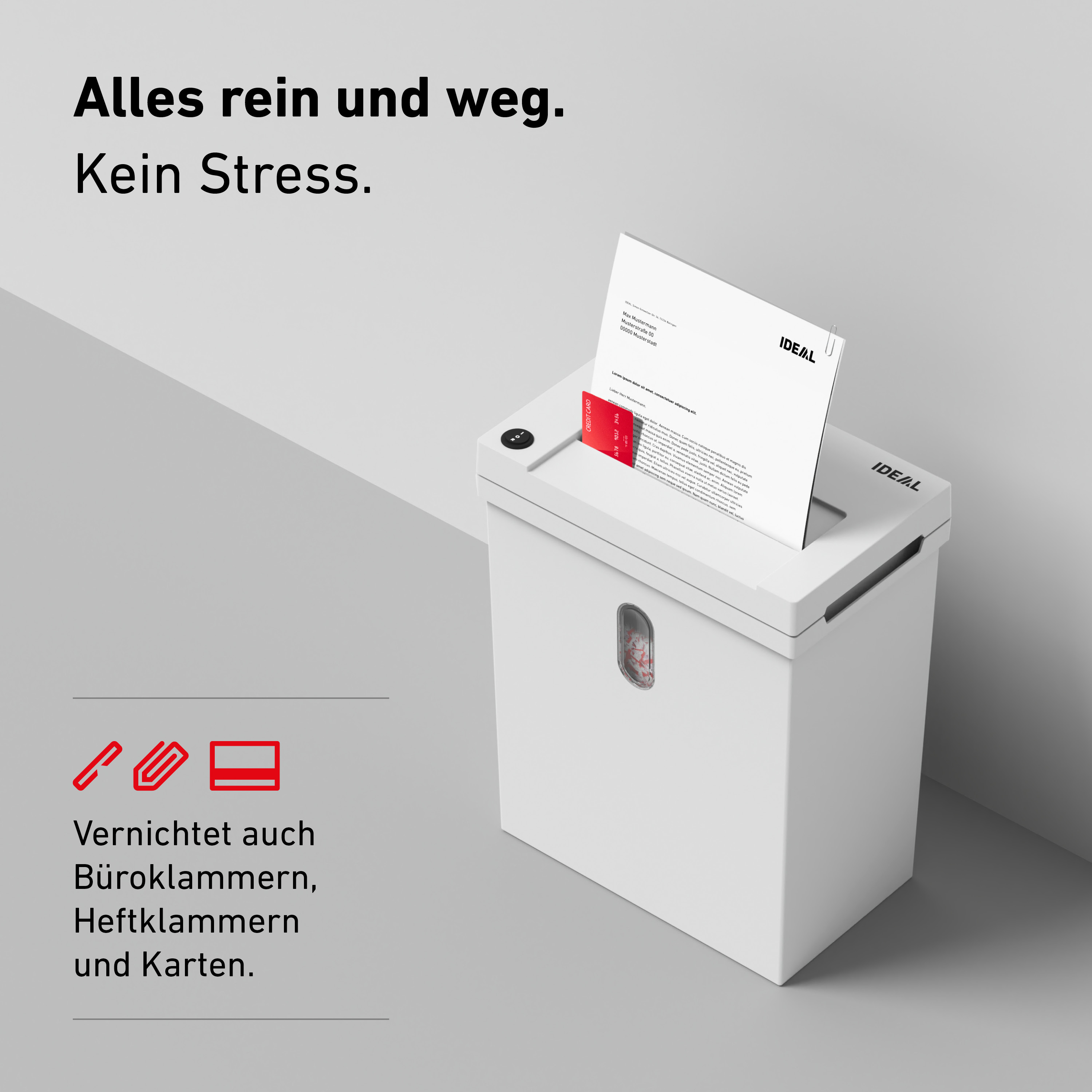 Ein weißer Aktenvernichter schreddert eine Kreditkarte und ein Dokument.