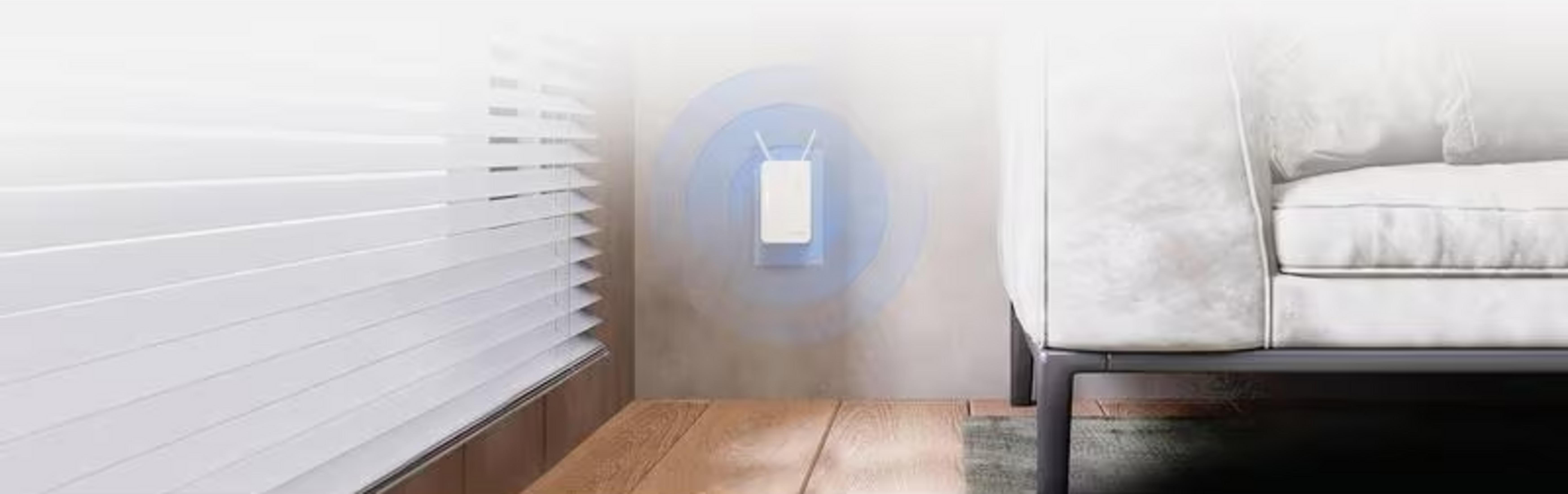 A white Wi-Fi extender on a wall with blue signal waves. Beside it are blinds and a couch.
