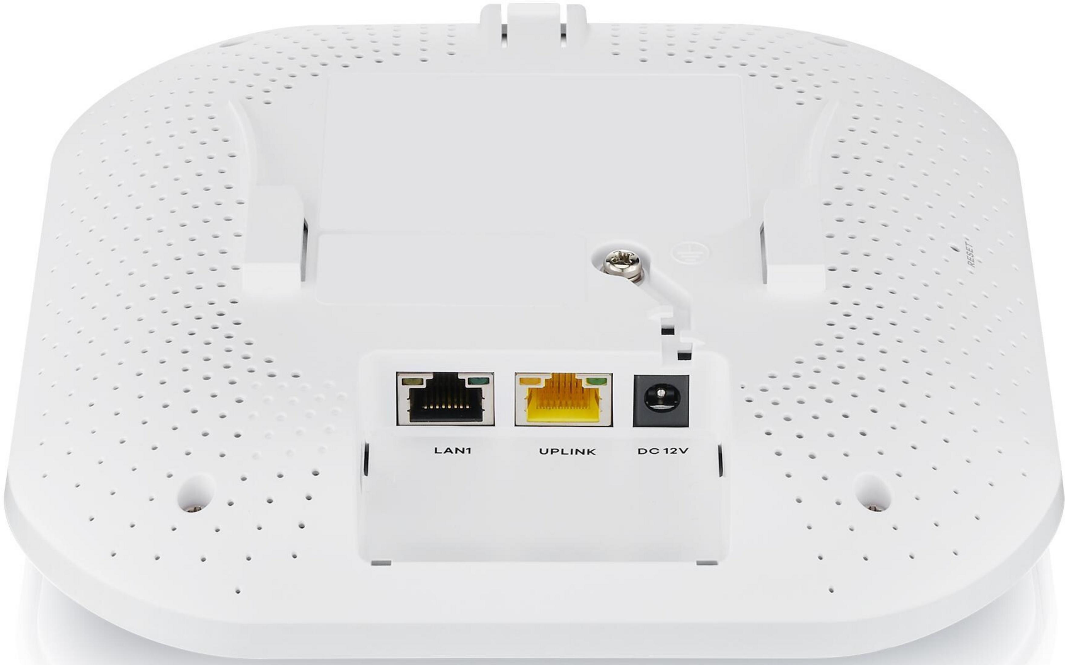 Parte trasera de un dispositivo blanco mostrando puertos LAN, UPLINK y DC 12V.