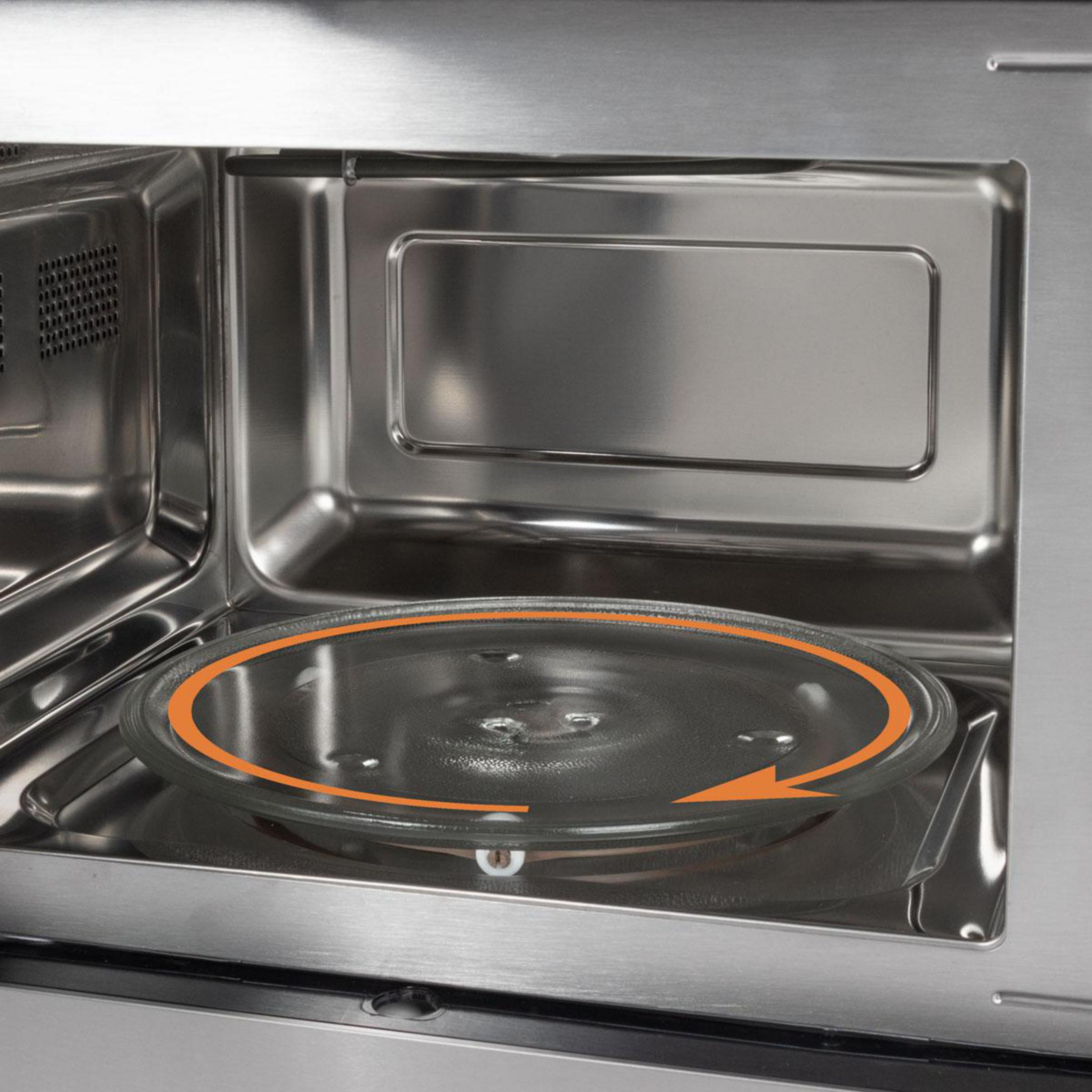 Szklany talerz obrotowy z pomarańczową strzałką wewnątrz kuchenki mikrofalowej.