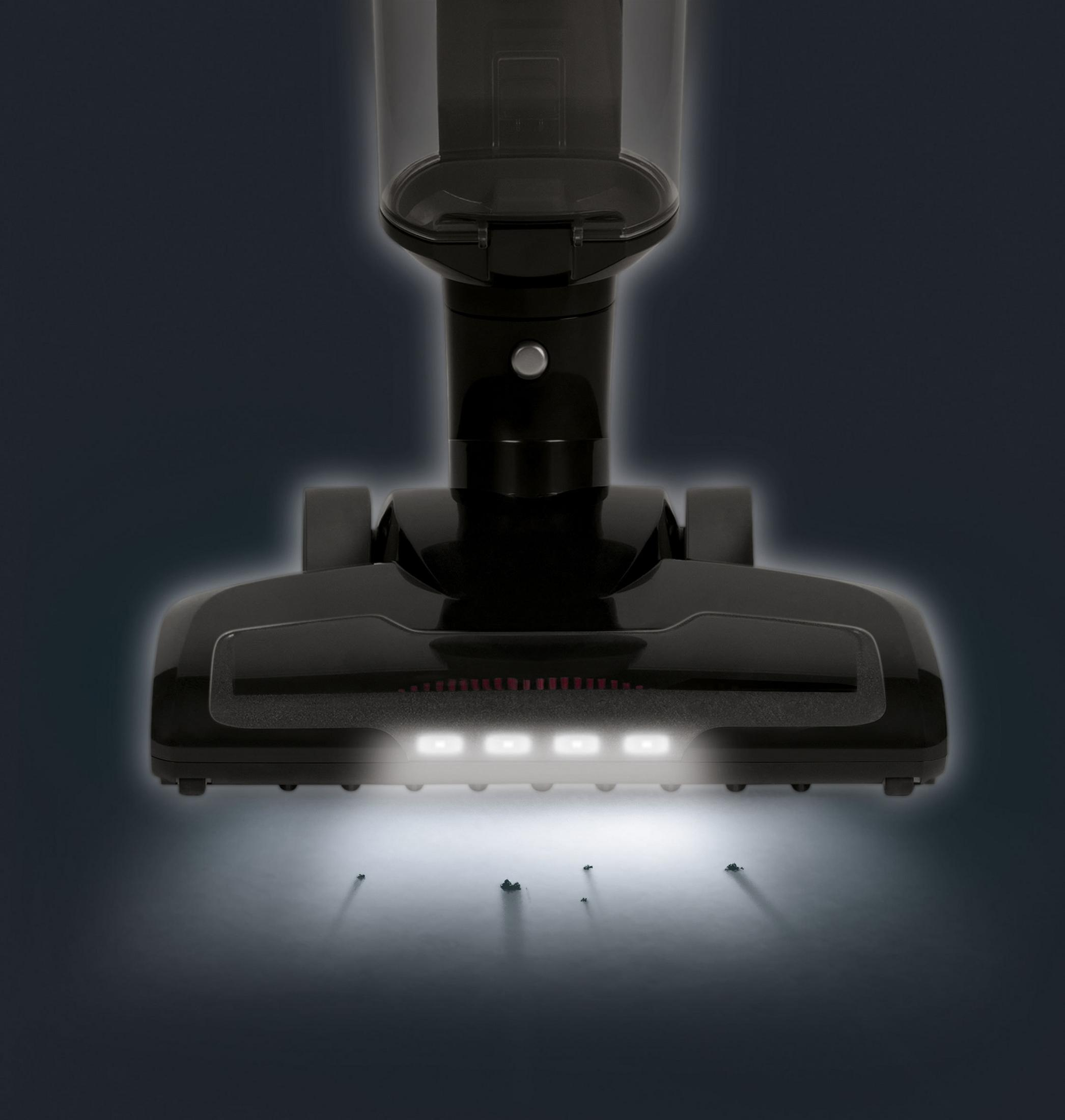 Una testina di aspirapolvere nera con luci aspira lo sporco.