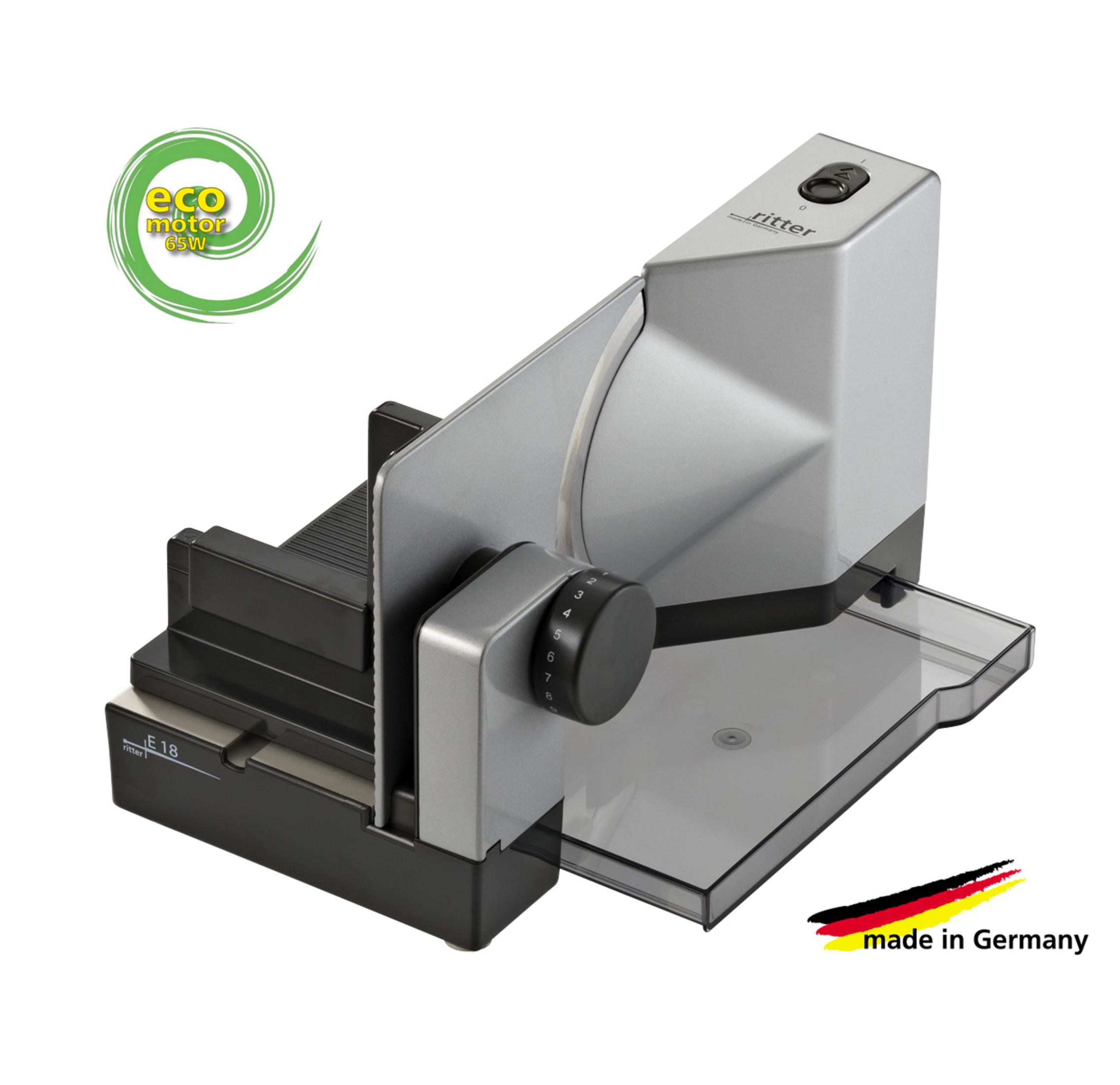 Srebrna krajalnica z czarnym wózkiem i pokrętłem regulacji.