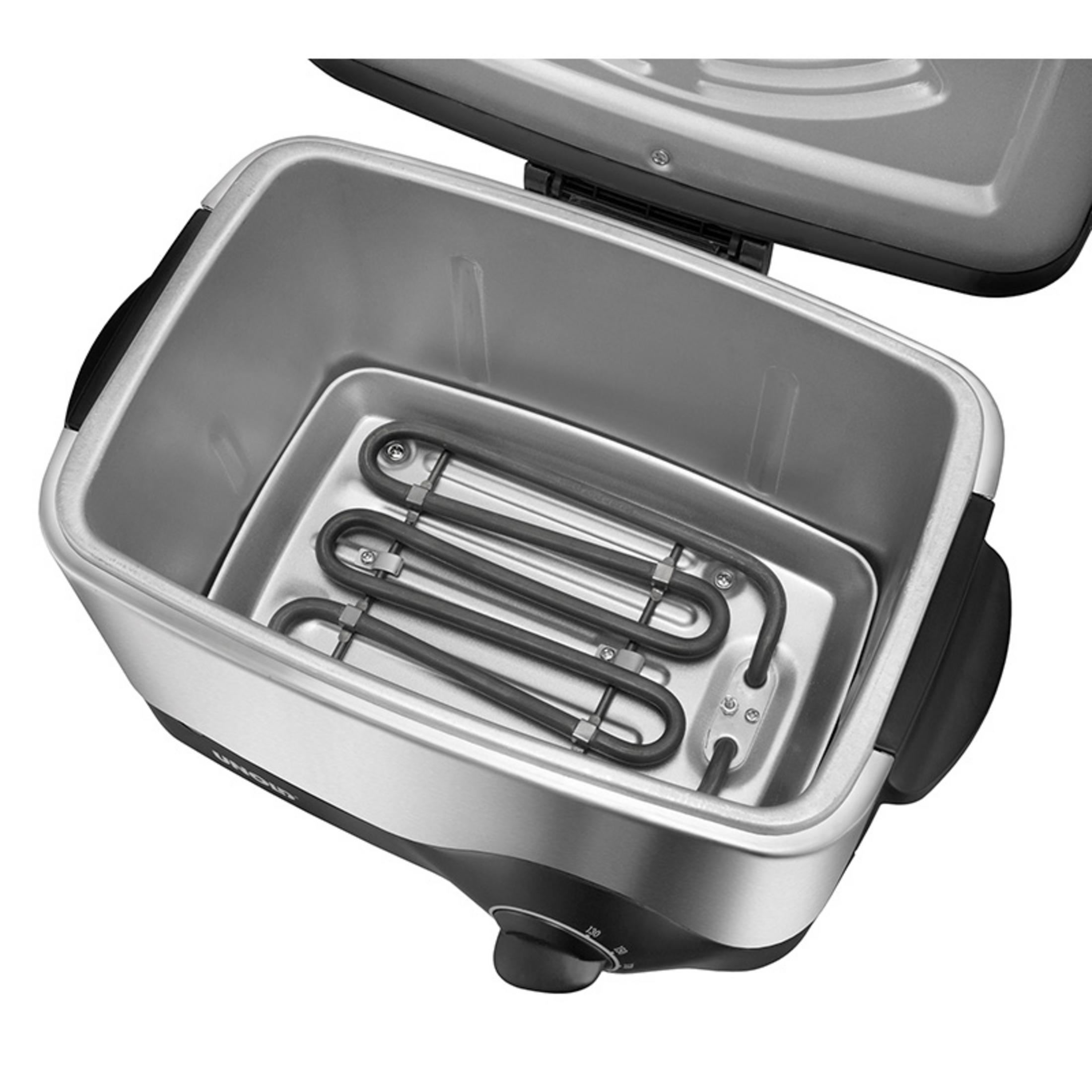 Otwarta elektryczna brytfanna z srebrnym wnętrzem i czarnymi elementami grzewczymi. Srebrne z zewnątrz.