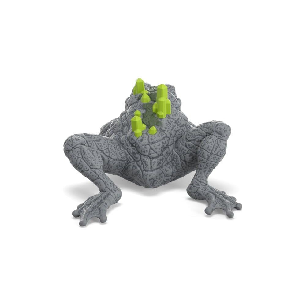 Graue Krötenfigur mit hellgrünen Kristallen auf dem Rücken, auf weißem Hintergrund.