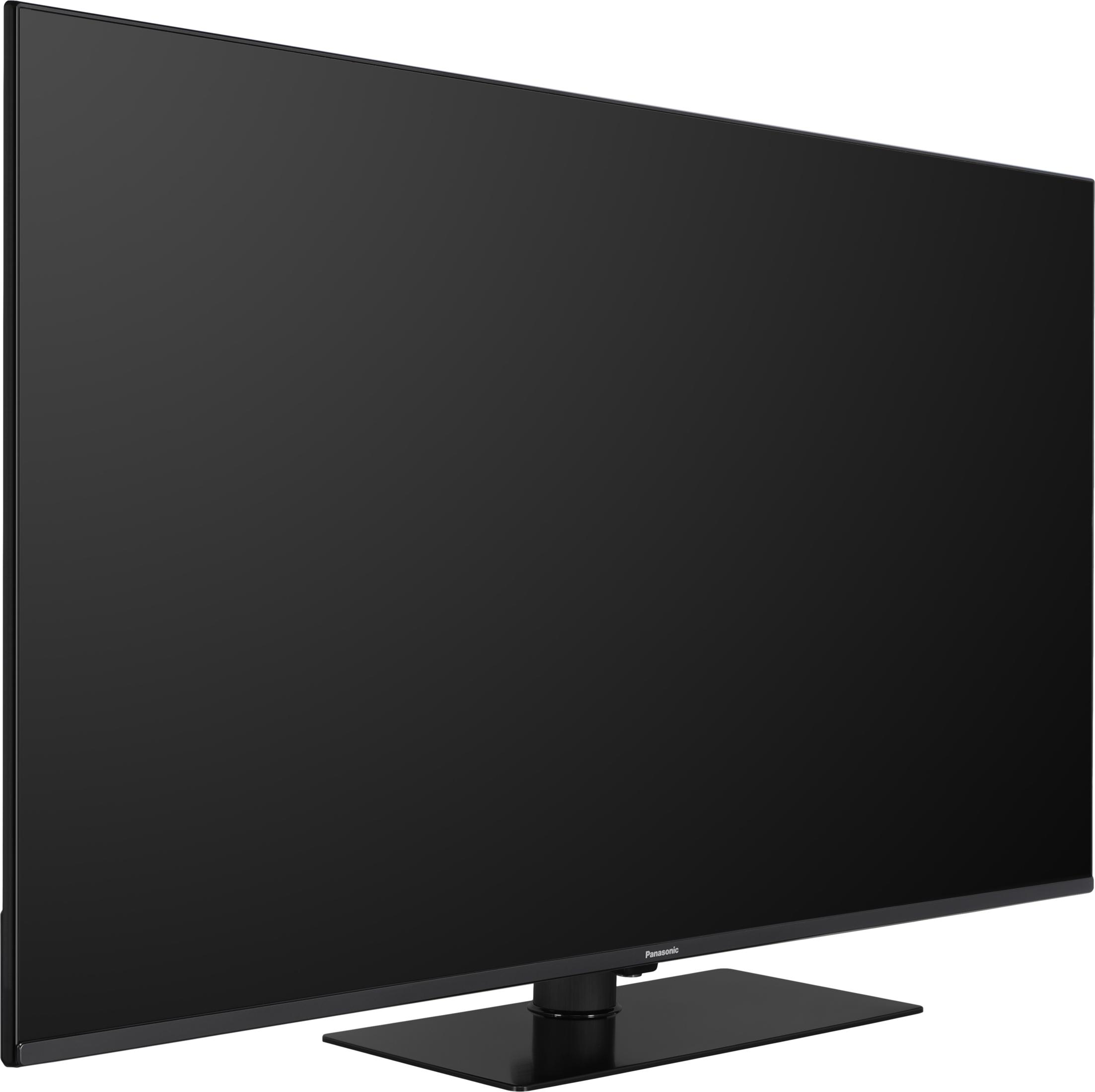 Una grande TV Panasonic a schermo piatto nero poggia su una base rettangolare.