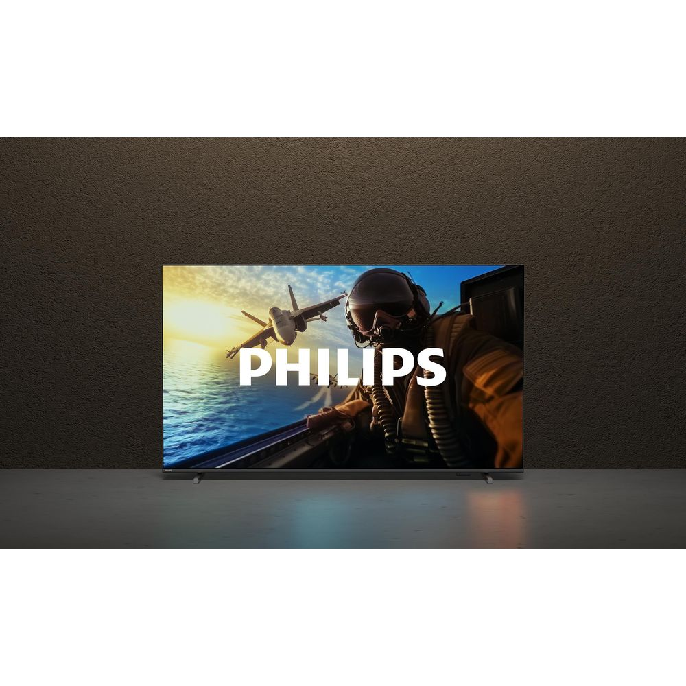 Pilot w myśliwcu leci nad morzem, logo Philips.