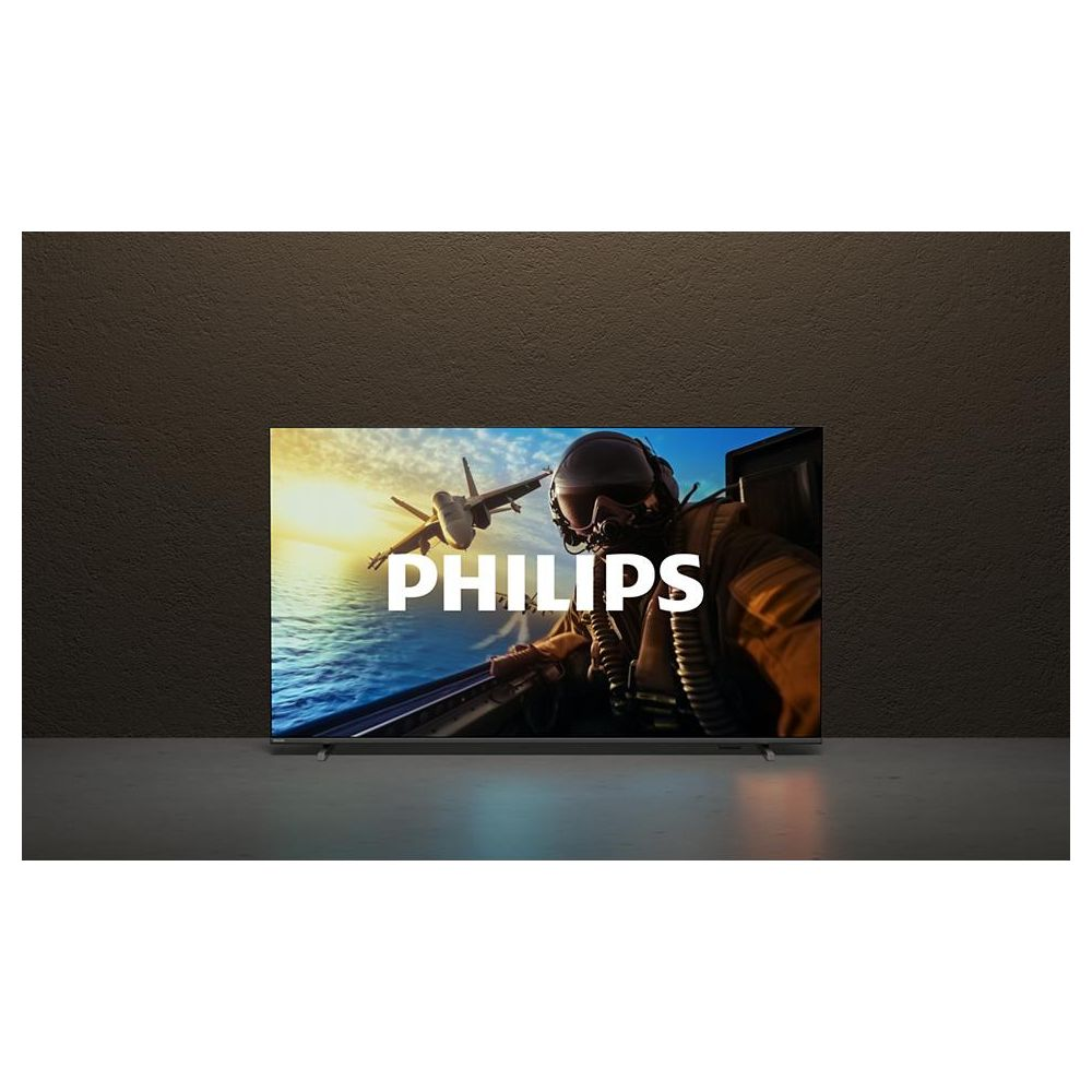 Pilot w kokpicie z myśliwcem na tle słonecznego nieba, logo Philips.