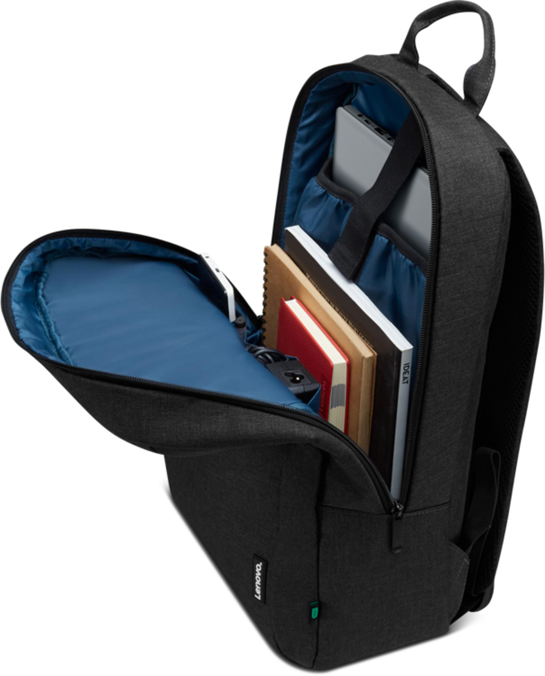 Un sac à dos noir avec compartiment principal ouvert, contenant livres, ordinateur portable et batterie.