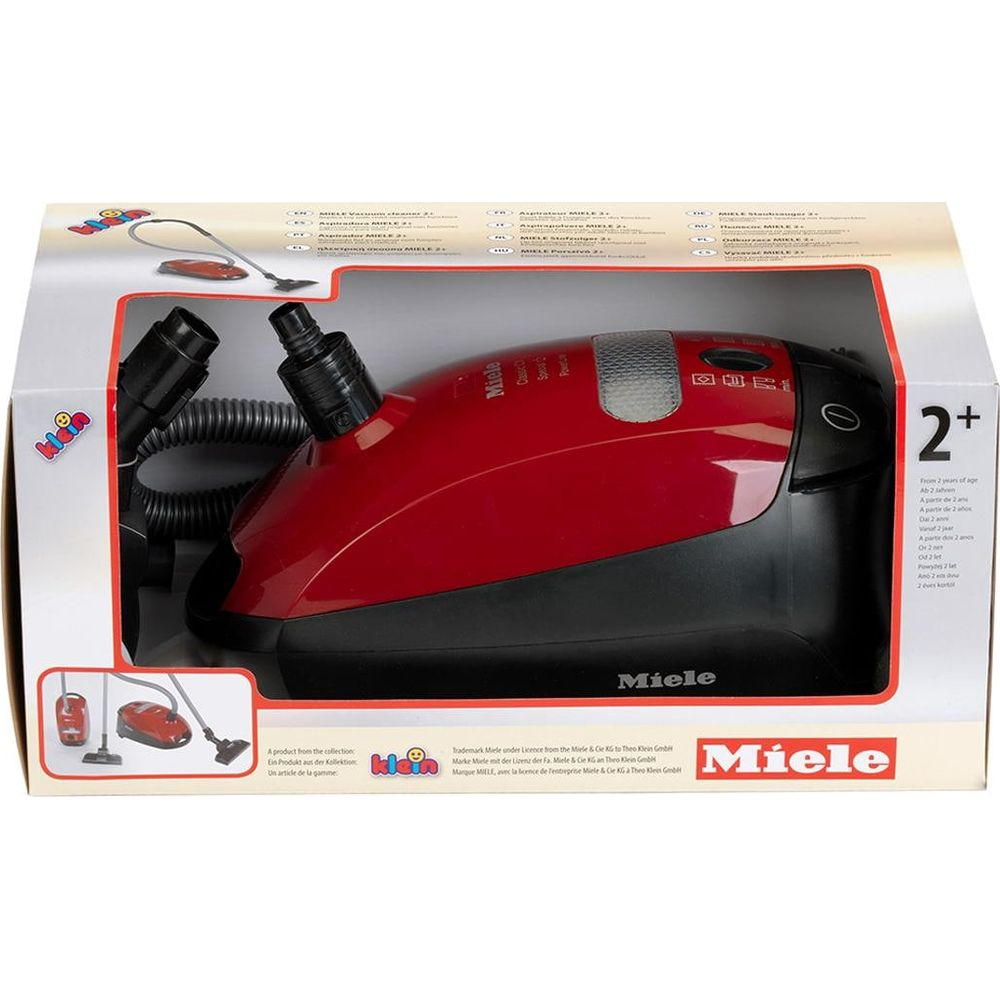 Roter Spielzeugstaubsauger von Miele im Karton, mit Schlauch und Aufsatz.