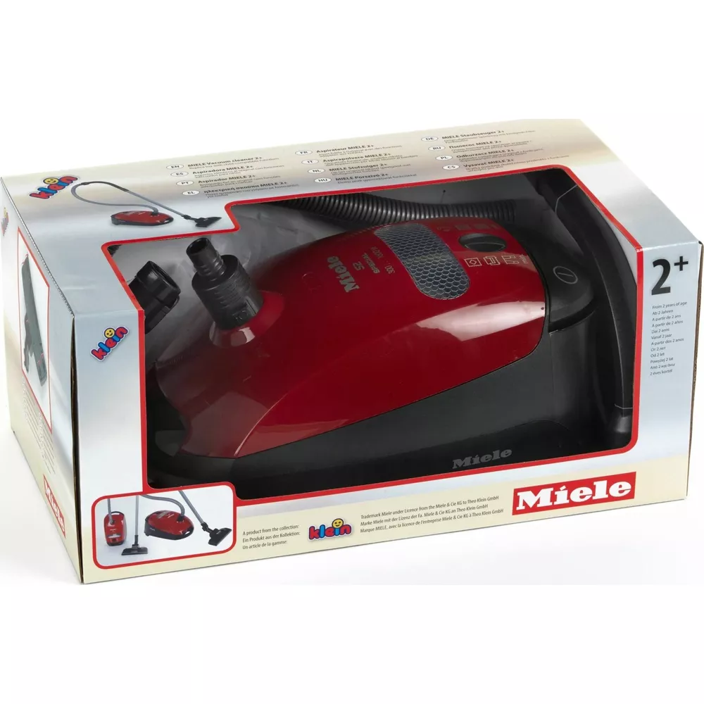 Roter Spielzeugstaubsauger von Miele im Karton mit Zubehör und Altersangabe 2+.