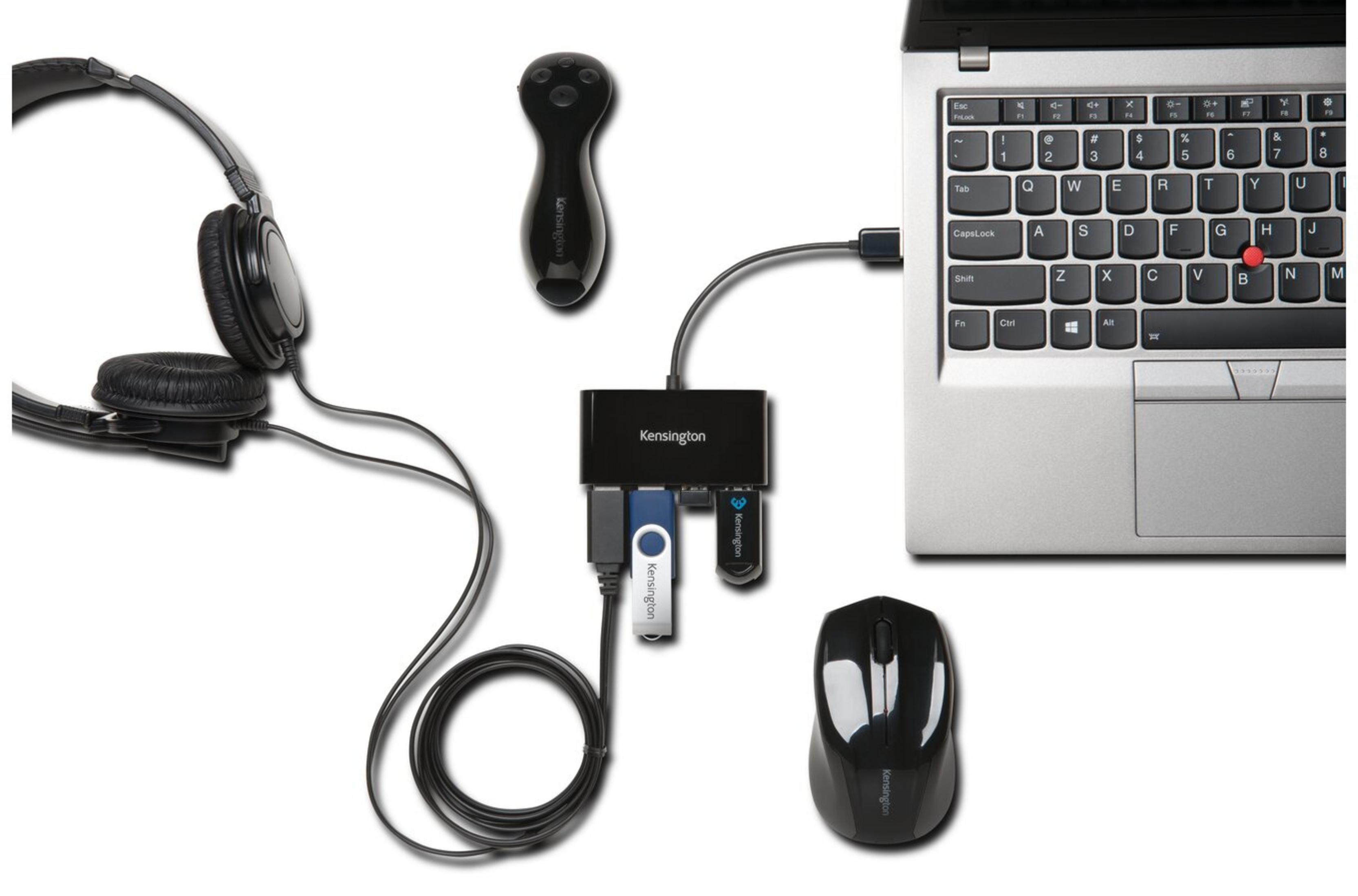 Cuffie nere, mouse, hub USB e laptop con unità USB collegata.