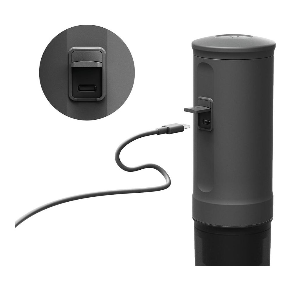 Szary kabel ładujący jest podłączony do ciemnego, cylindrycznego urządzenia.