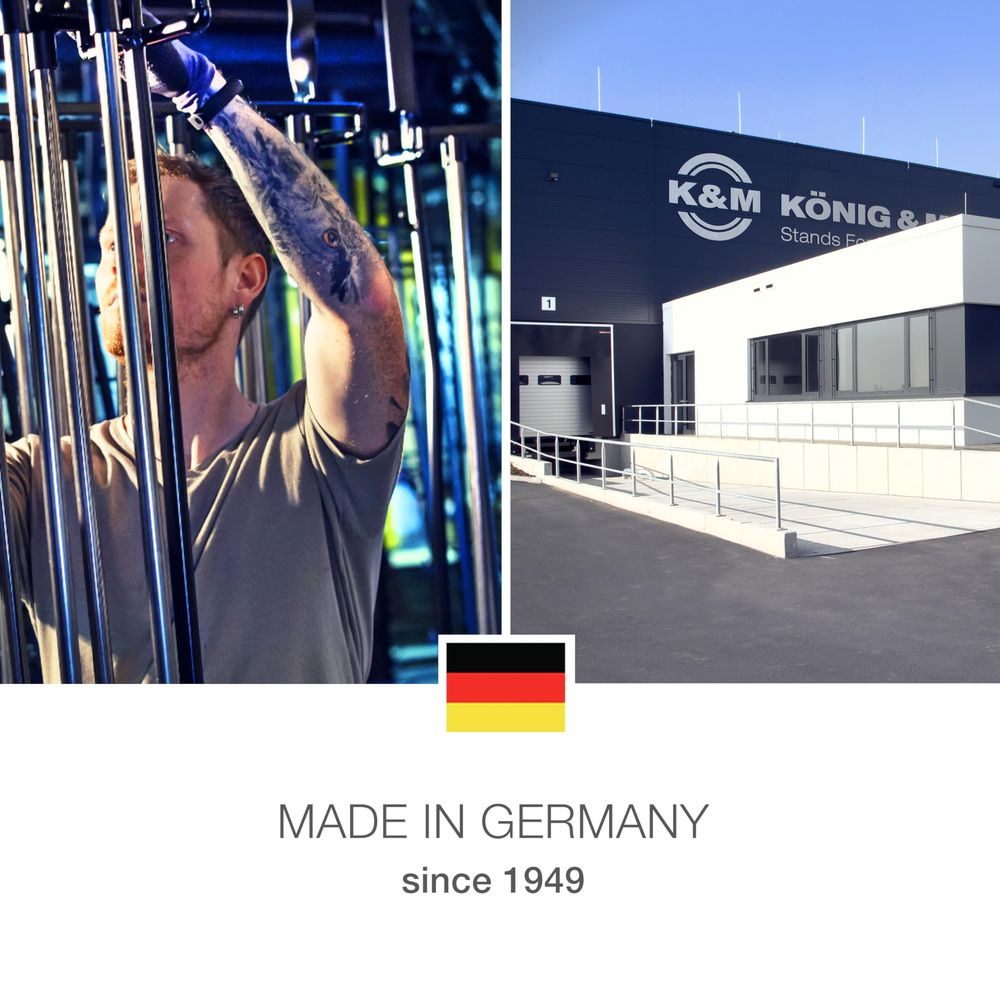 Mann mit Tätowierung am Arm und ein K&M Gebäude mit deutscher Flagge.