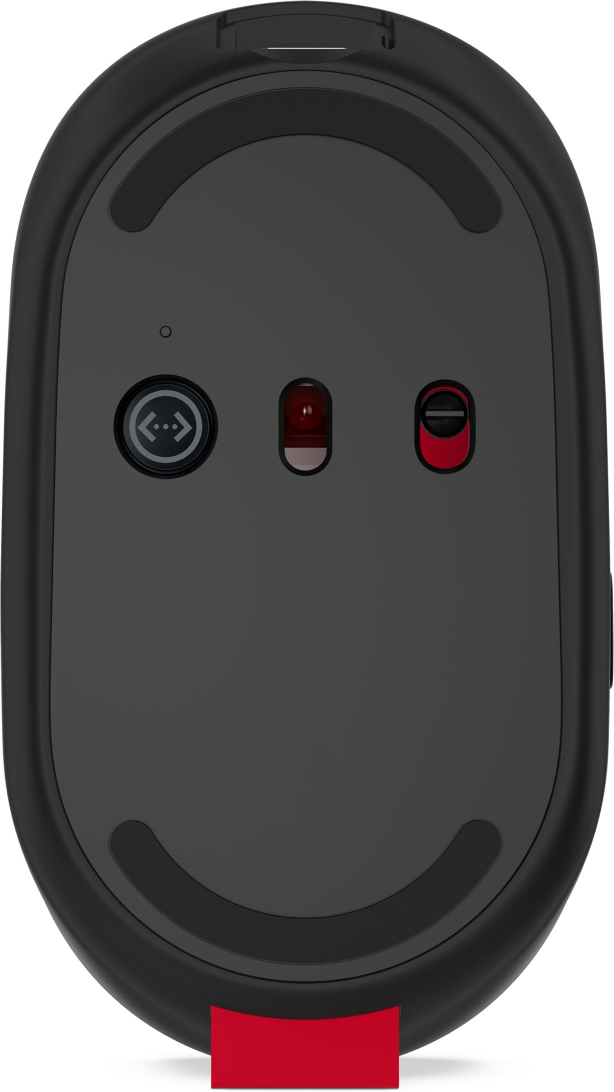 Spód czarnej myszy komputerowej z czerwonymi akcentami i przełącznikiem.