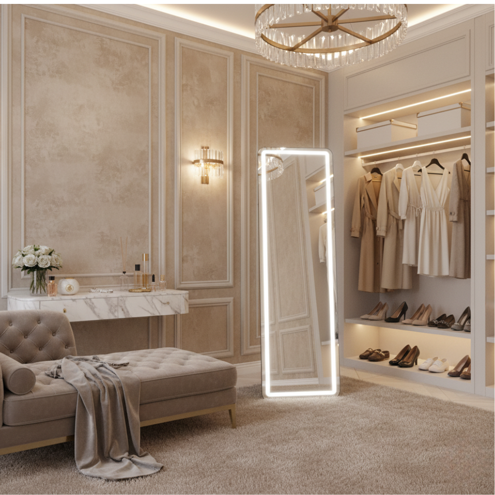 A luxurious bedroom featuring a vanity, chaise lounge, and walk-in closet with clothes.