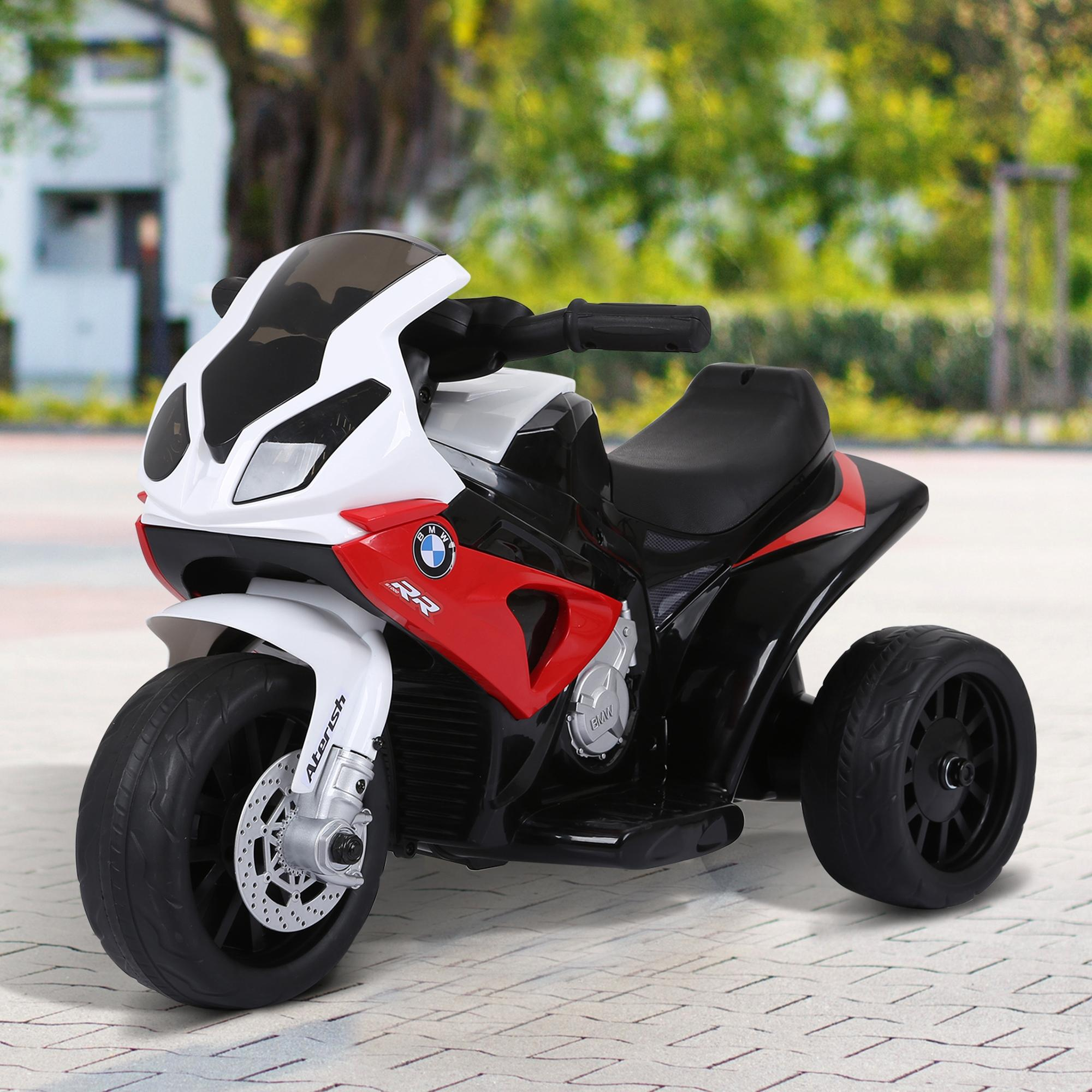 Una motocicleta de juguete triciclo roja, blanca y negra con logo BMW.