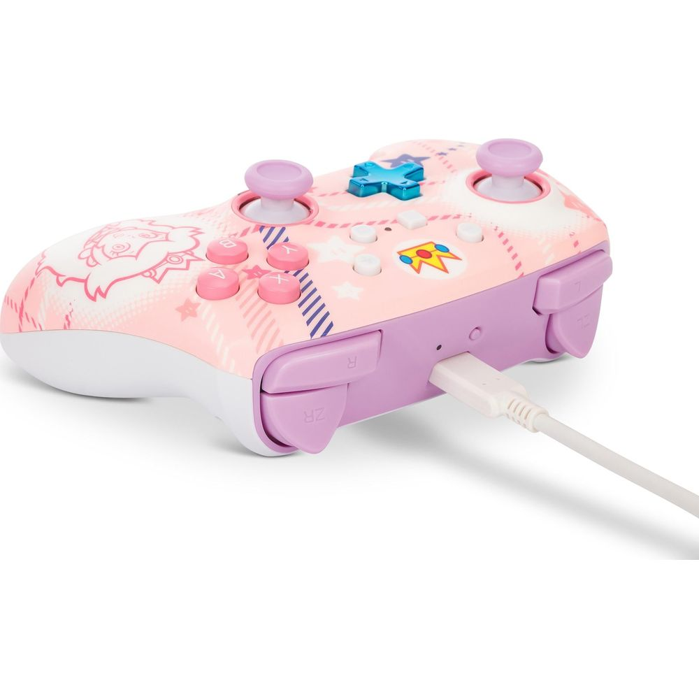 Różowy kontroler Nintendo Switch z grafiką, podłączony do białego kabla USB.