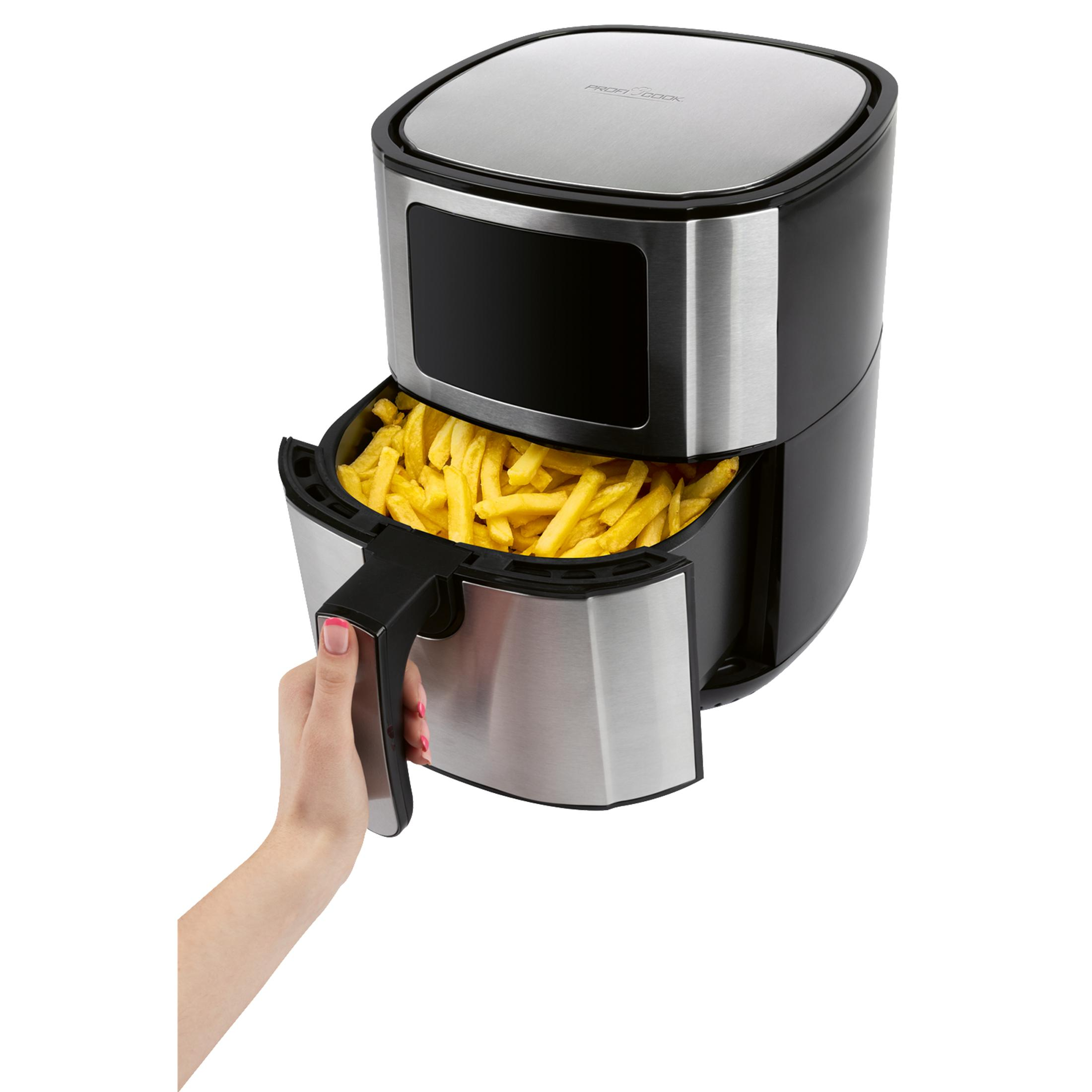 Ręka wyciąga szufladę srebrno-czarnej frytkownicy beztłuszczowej, wypełnionej frytkami.