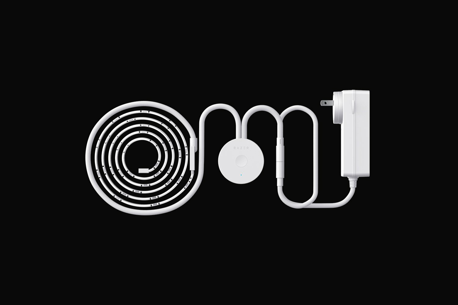 Biała taśma LED Razer, kontroler i zasilacz na czarnym tle.