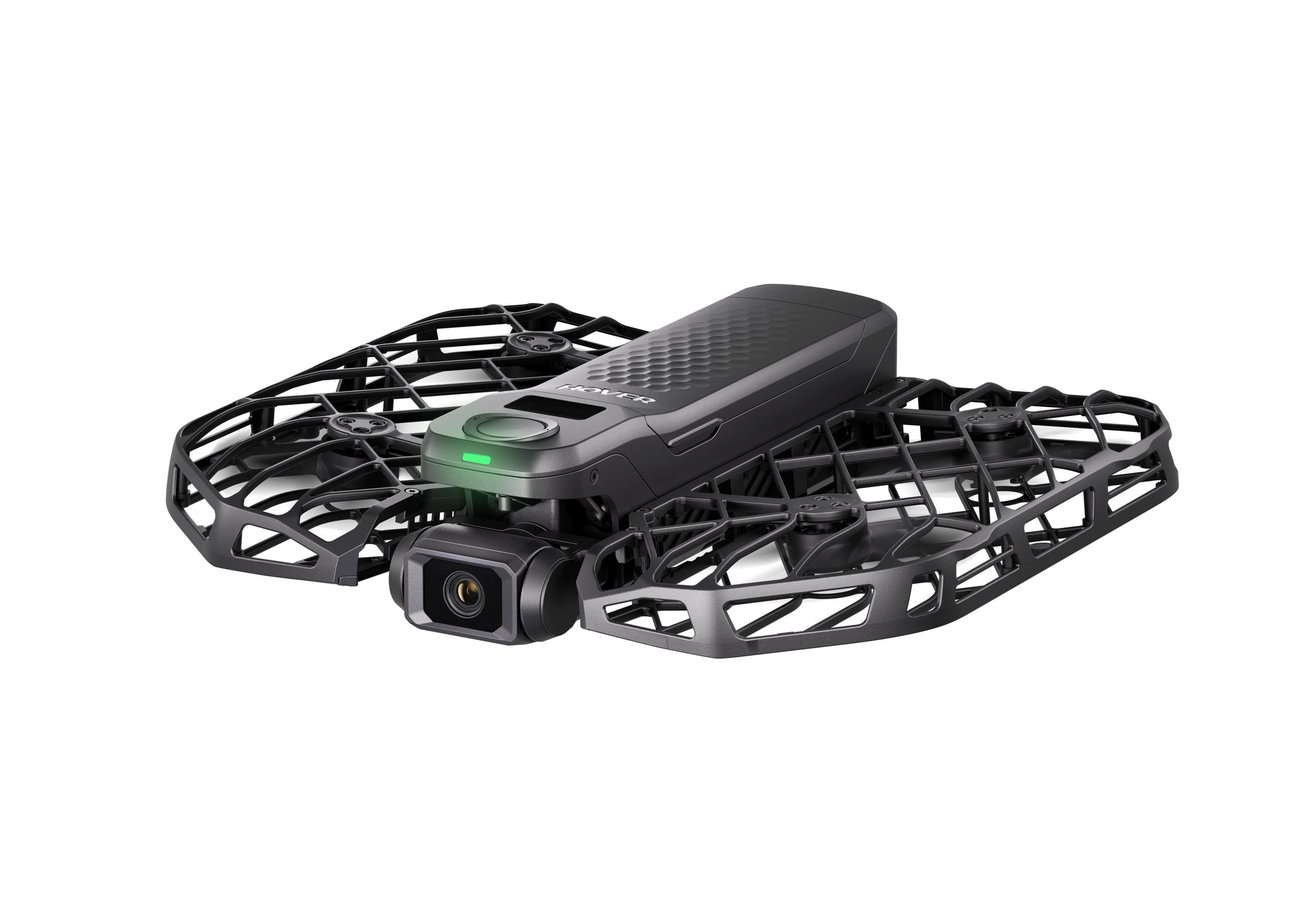 Czarny, kompaktny korpus drona z kamerą i osłonami śmigieł.