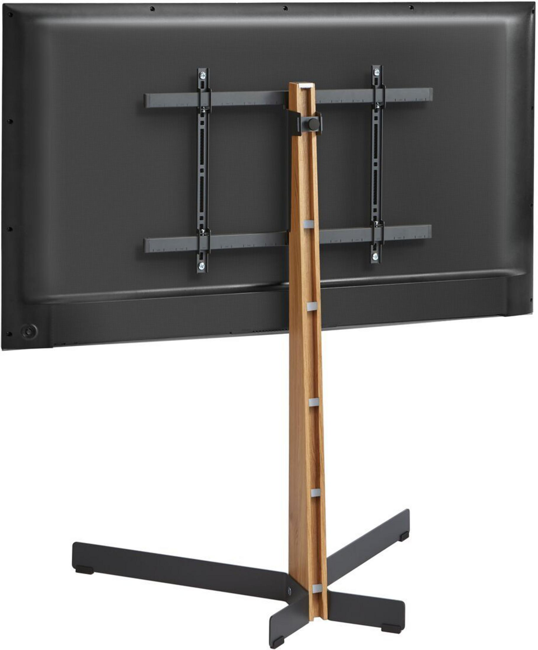 Tył telewizora na drewnianym stojaku z czarną metalową podstawą.